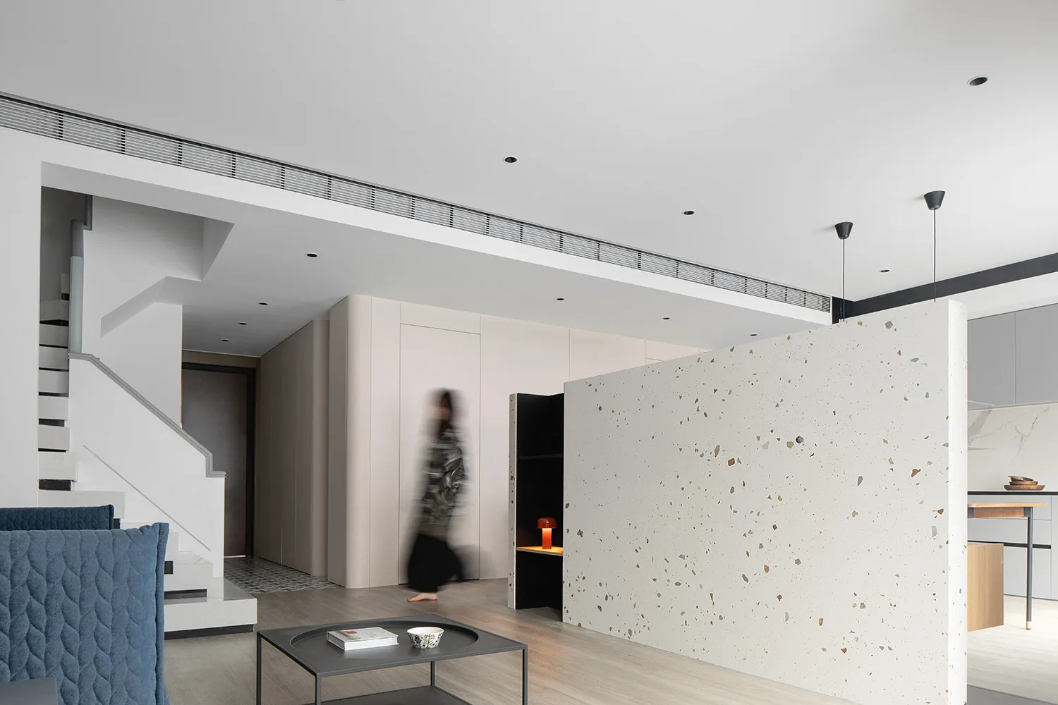 A modern interior featuring a terrazzo floor and minimalist design.