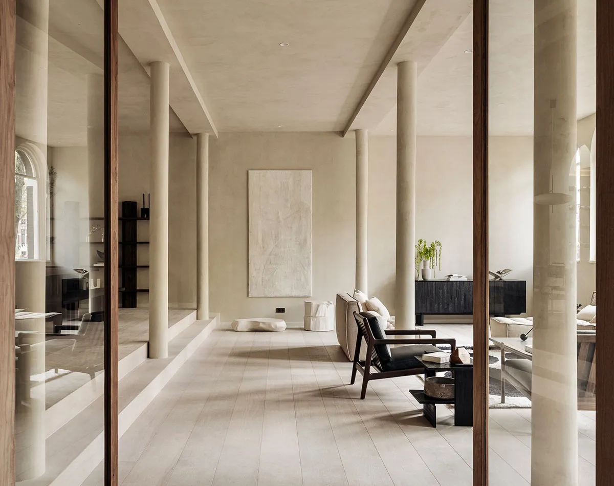 A minimalist living room featuring wood and concrete materials.