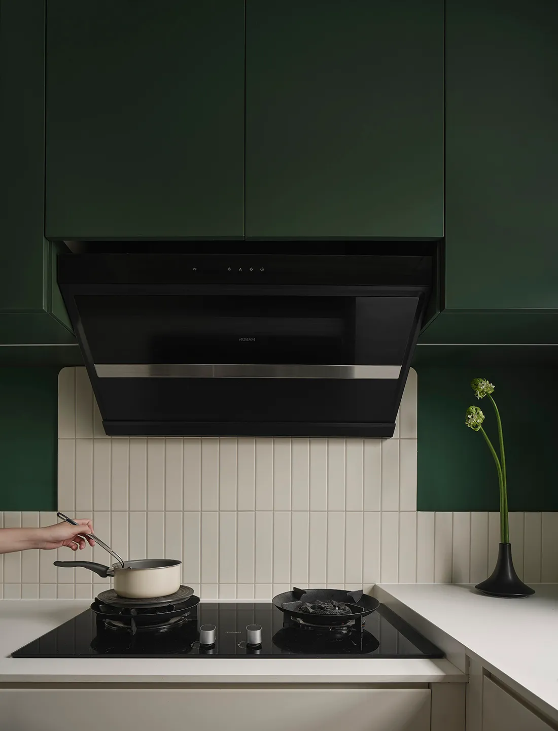 A minimalist residential kitchen with green cabinetry and ceramic tile flooring