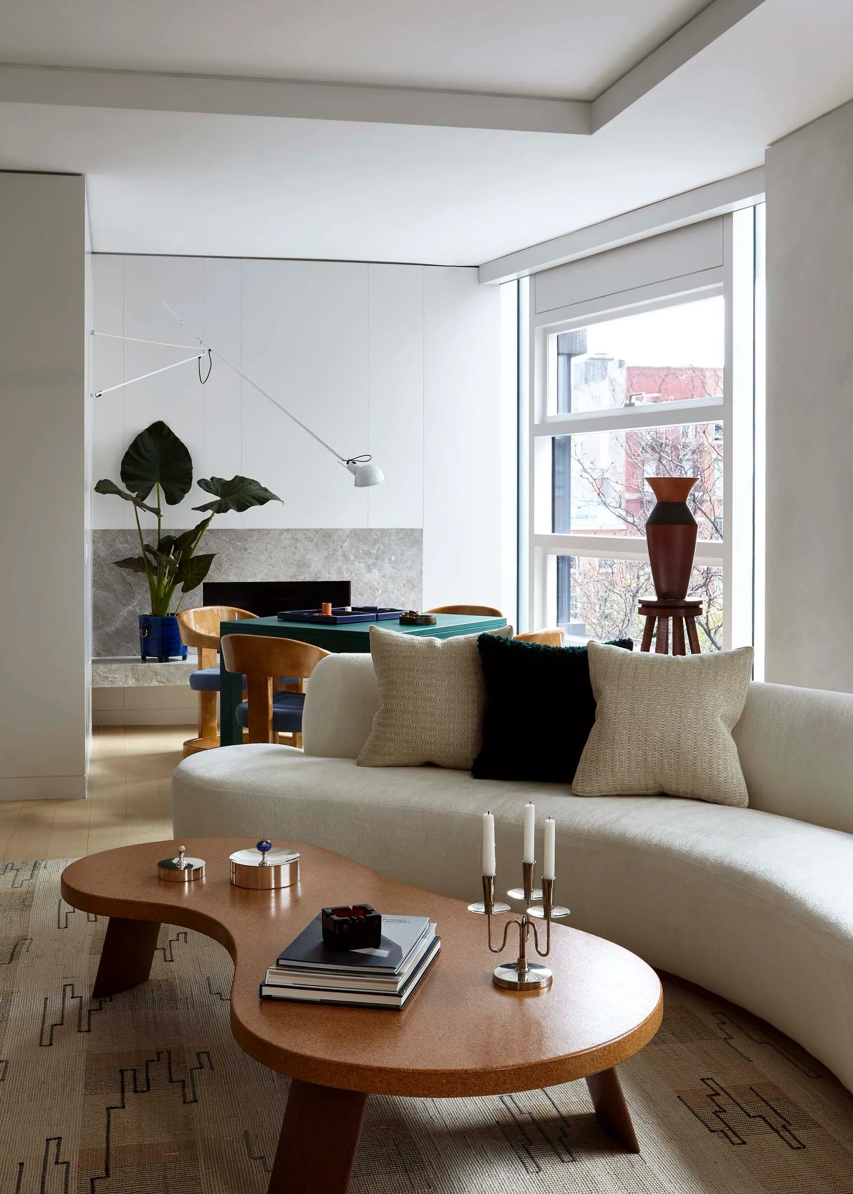 Modern minimalist residential living room with neutral colors, wood accents, and fabric furniture