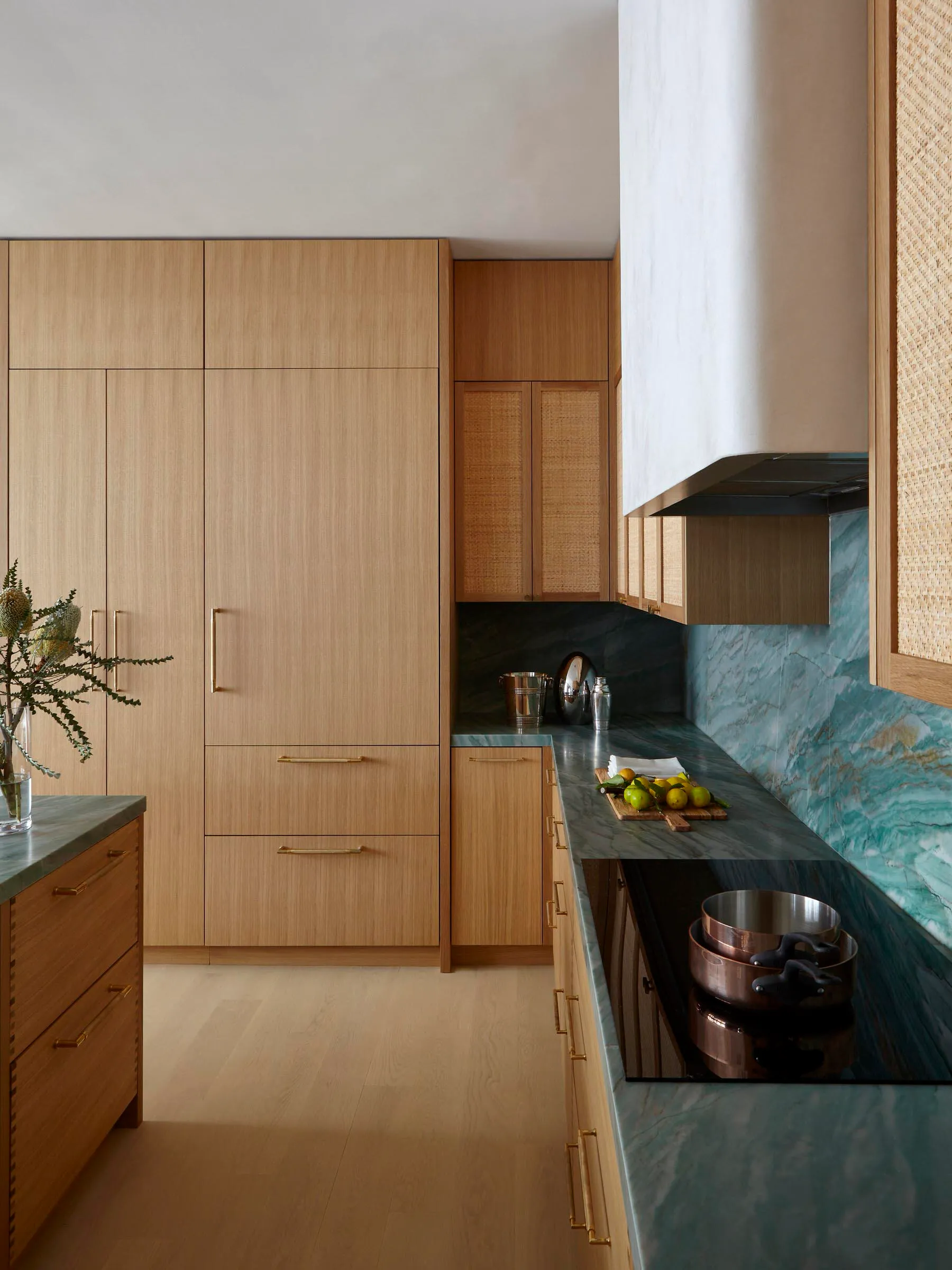 Contemporary kitchen featuring wooden cabinets and marble countertops.