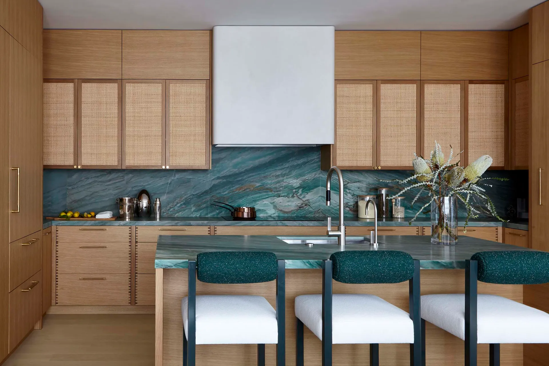 A modern residential kitchen featuring a stone countertop and white appliances.