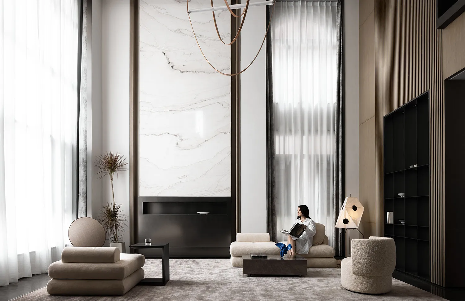 A modern living room featuring marble, concrete, and textured fabric materials.