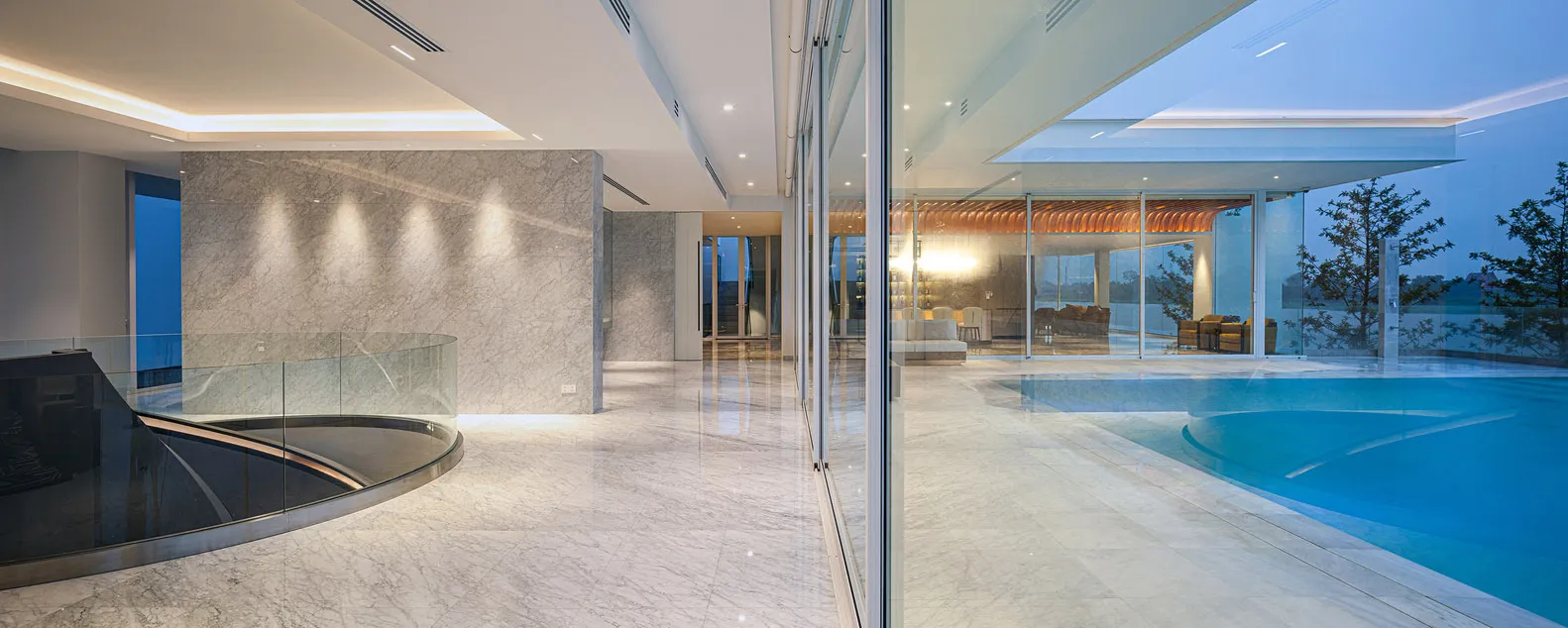 A modern residence featuring marble flooring and a large swimming pool.