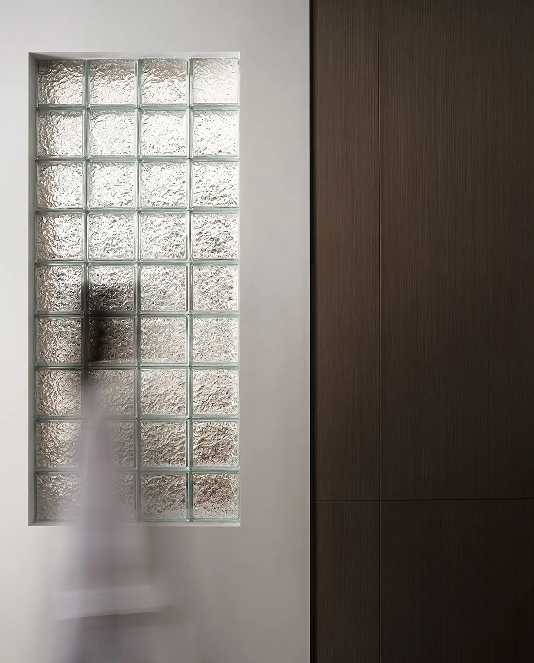 A minimalist glass block window with textured glass panels in a modern architectural setting.