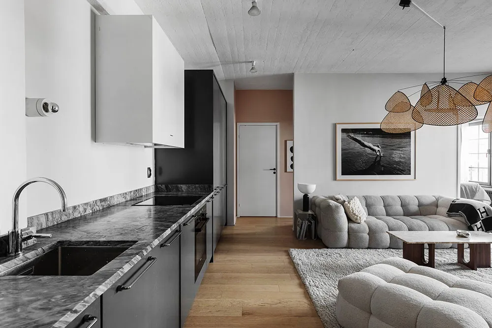 modern living space with marble countertops and beige sofa