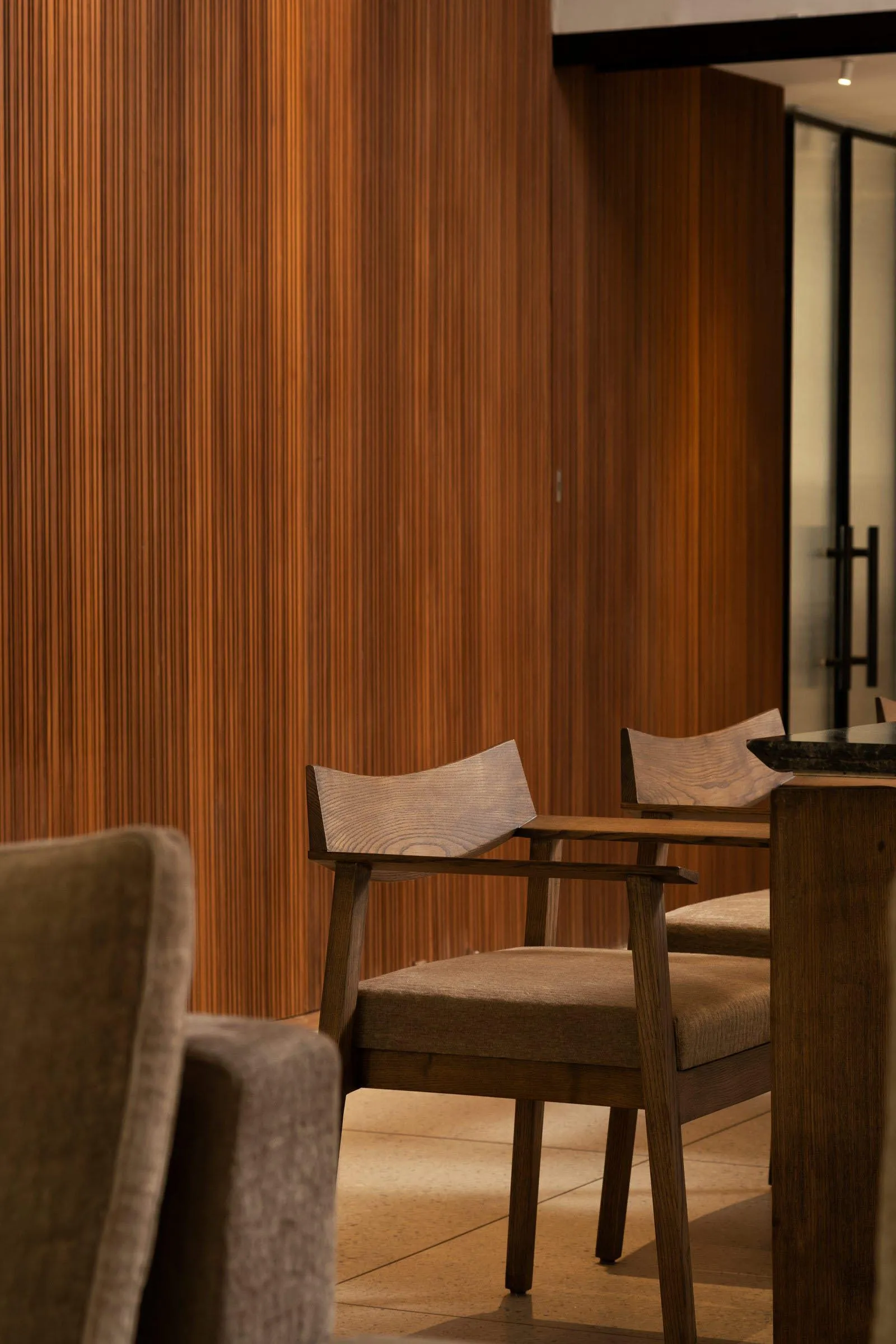 Modern restaurant interior with wooden furniture and seating.