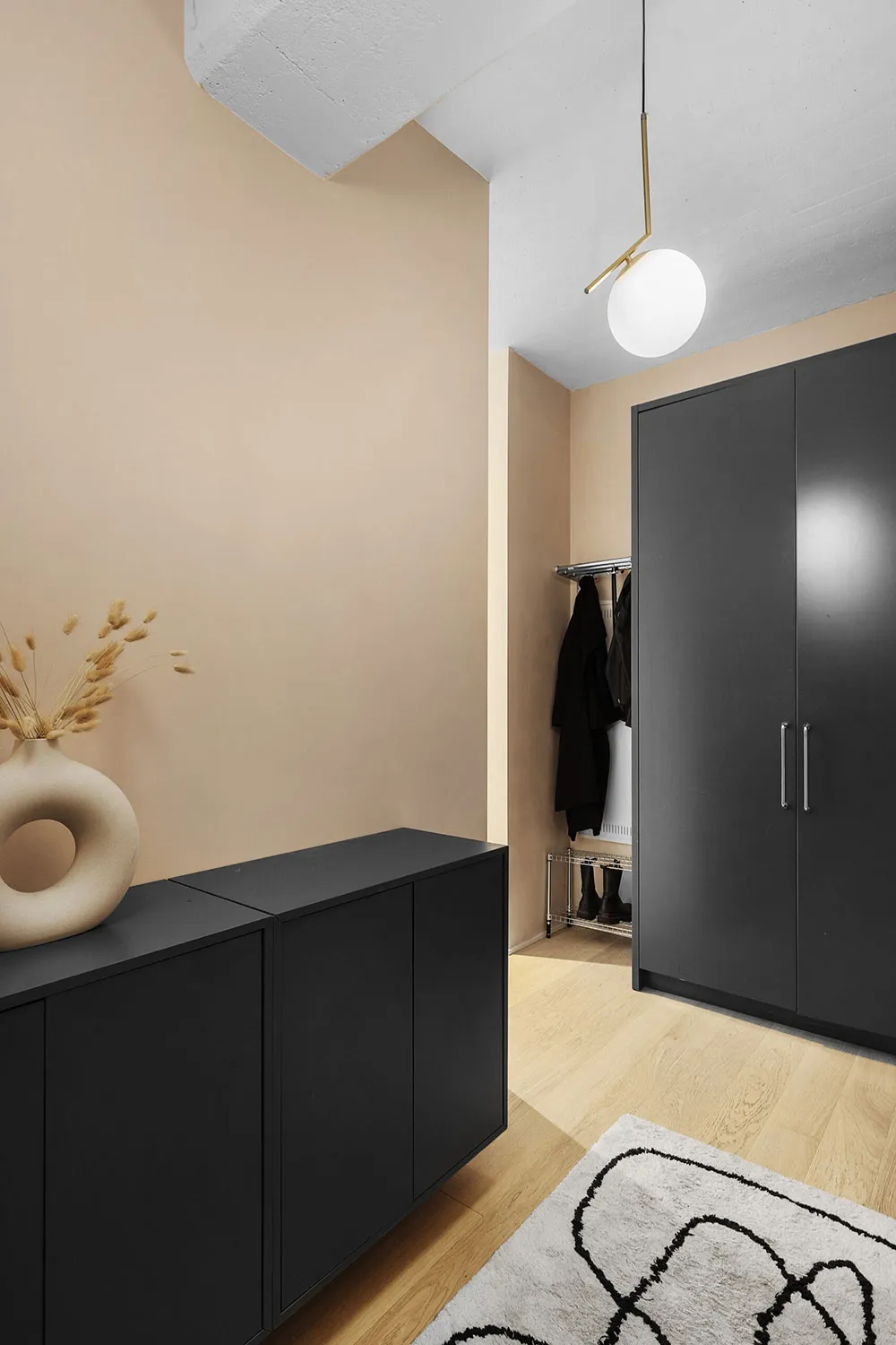 A modern interior featuring black storage units and minimalist design.