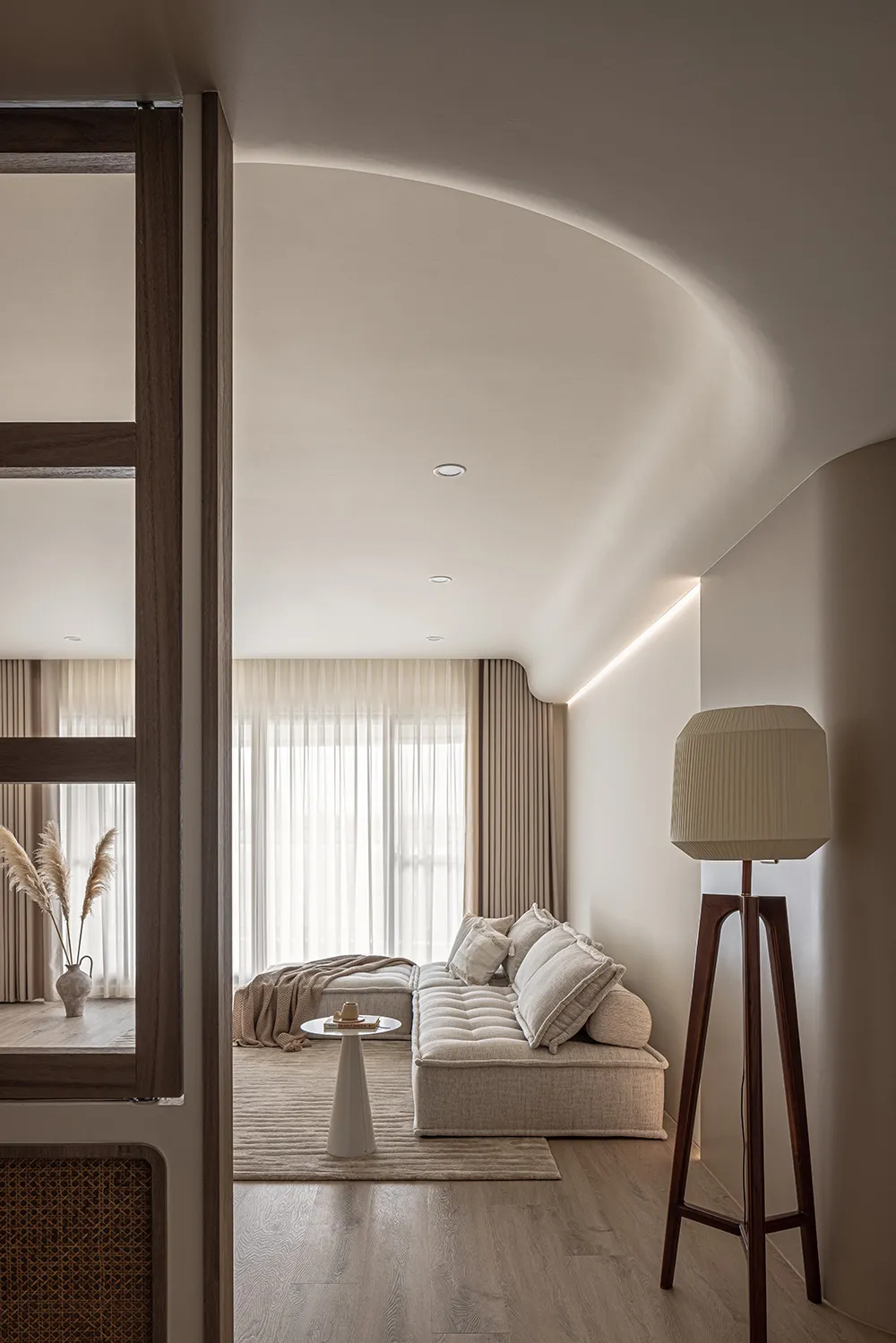 Cozy living room featuring neutral-toned furniture and decor, minimalist design, and ample natural light.