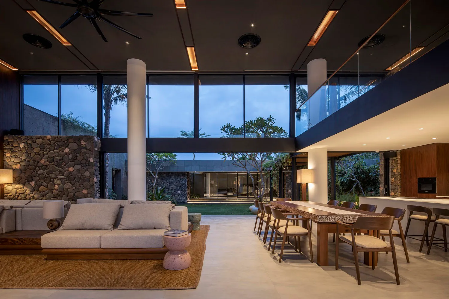 Modern minimalist living room featuring concrete, glass, and wood materials.