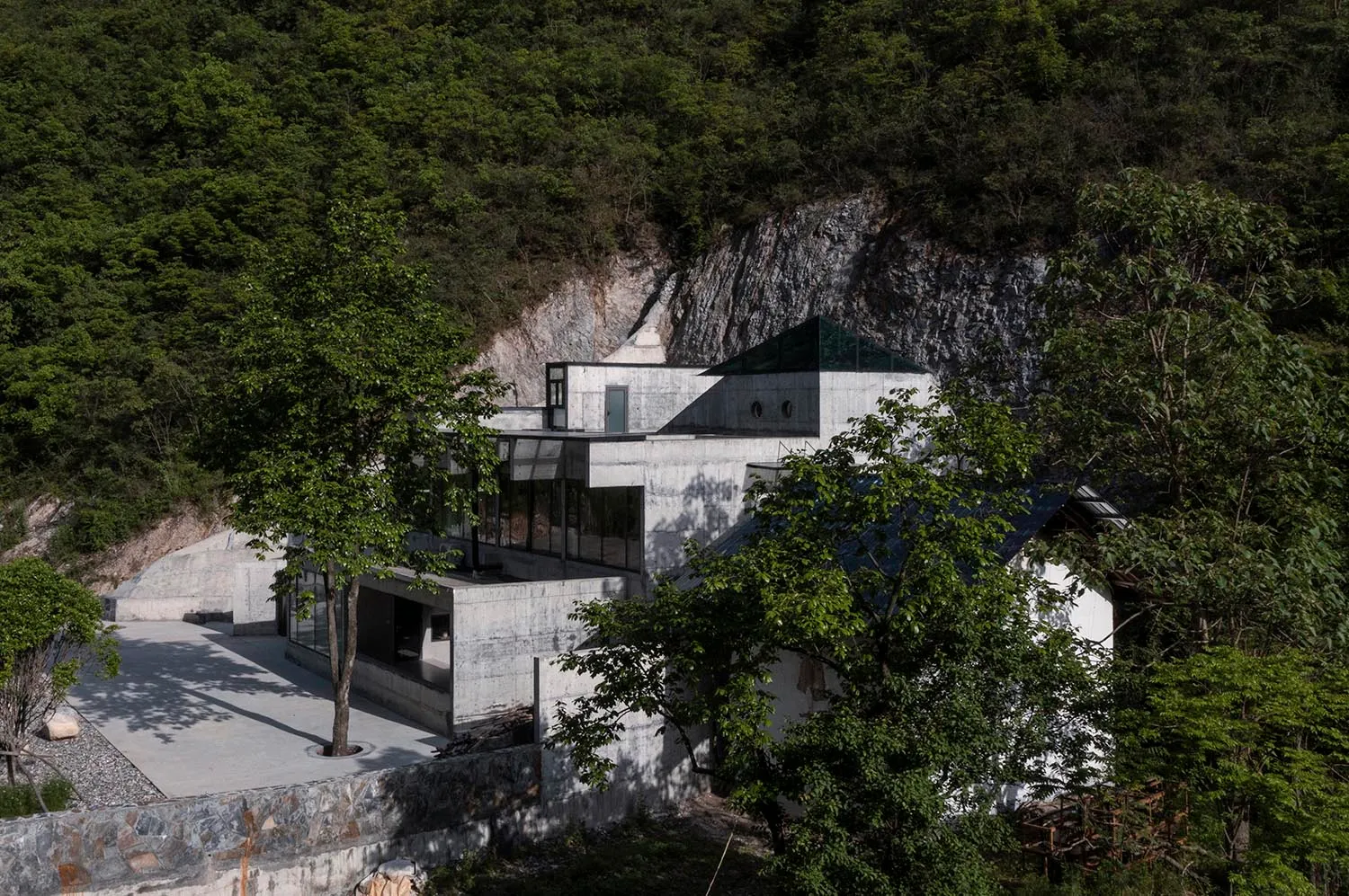 Modern house with geometric design and concrete exterior.