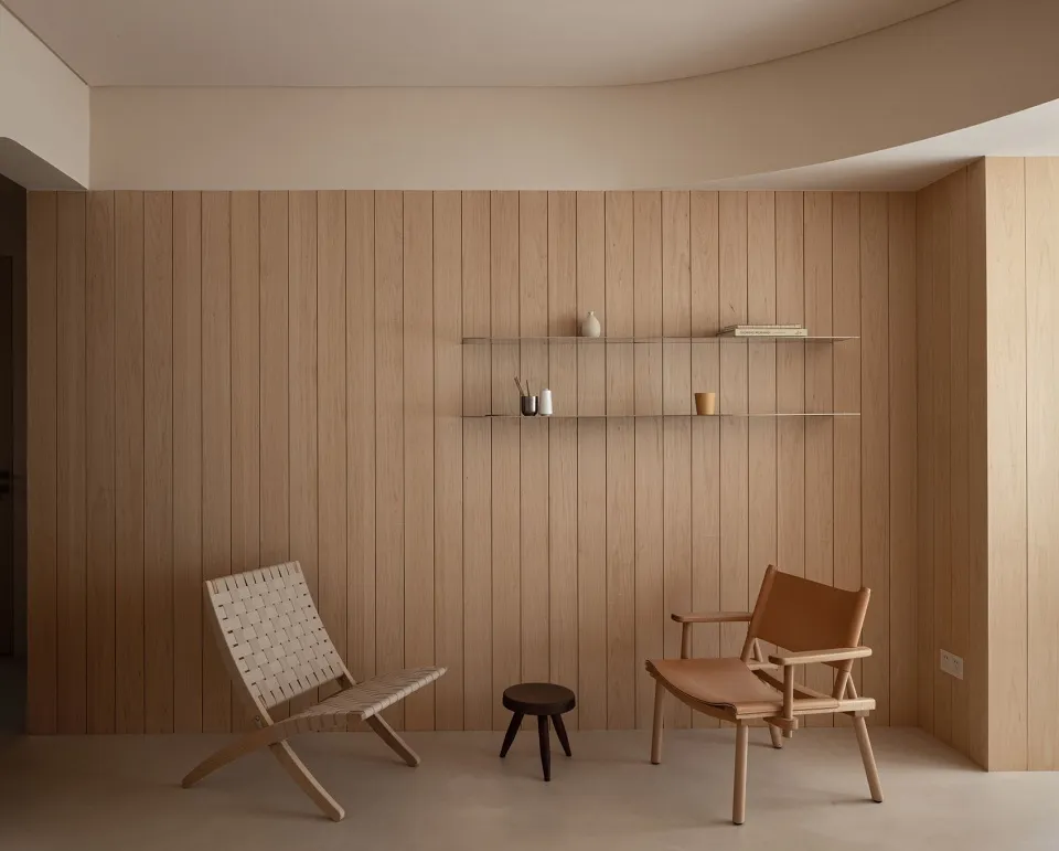 Modern interior space featuring wooden paneling, minimalist furniture, and a sleek, contemporary design.
