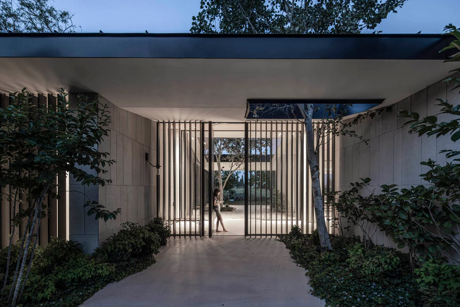 Modern entrance with metal railings and a path.