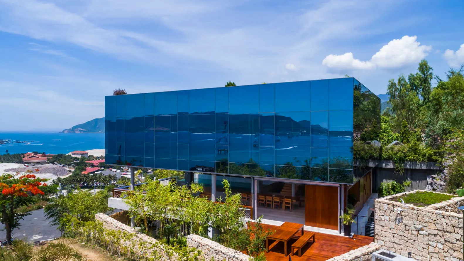 A modern glass residential building with panoramic ocean views.