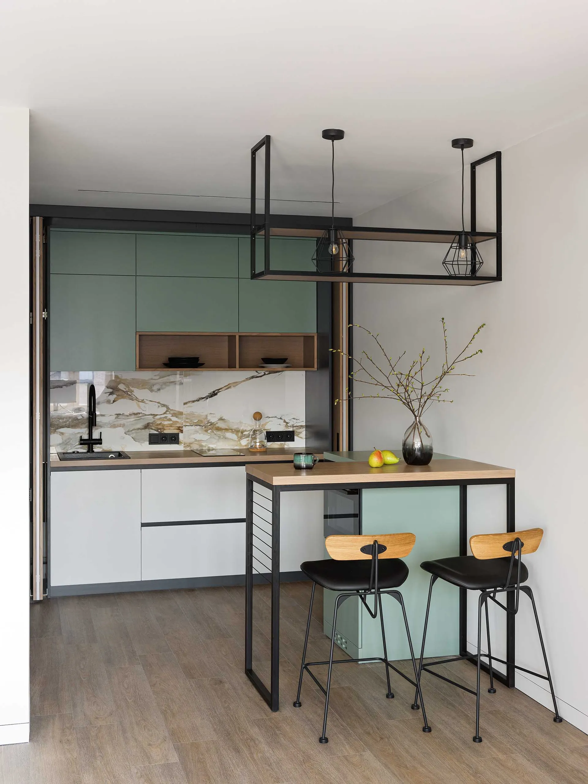 Modern apartment kitchen featuring concrete countertops, white cabinets, and minimalist design.