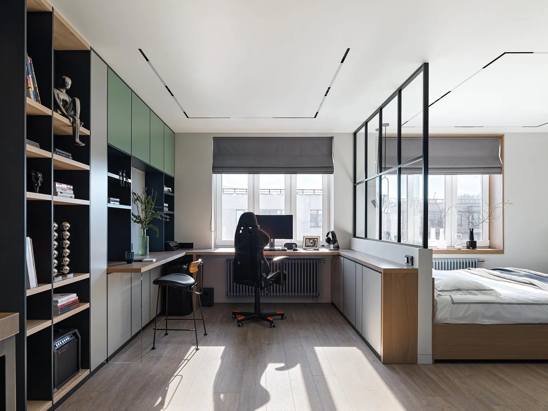 A modern bedroom featuring glass windows, a desk, and a bed.