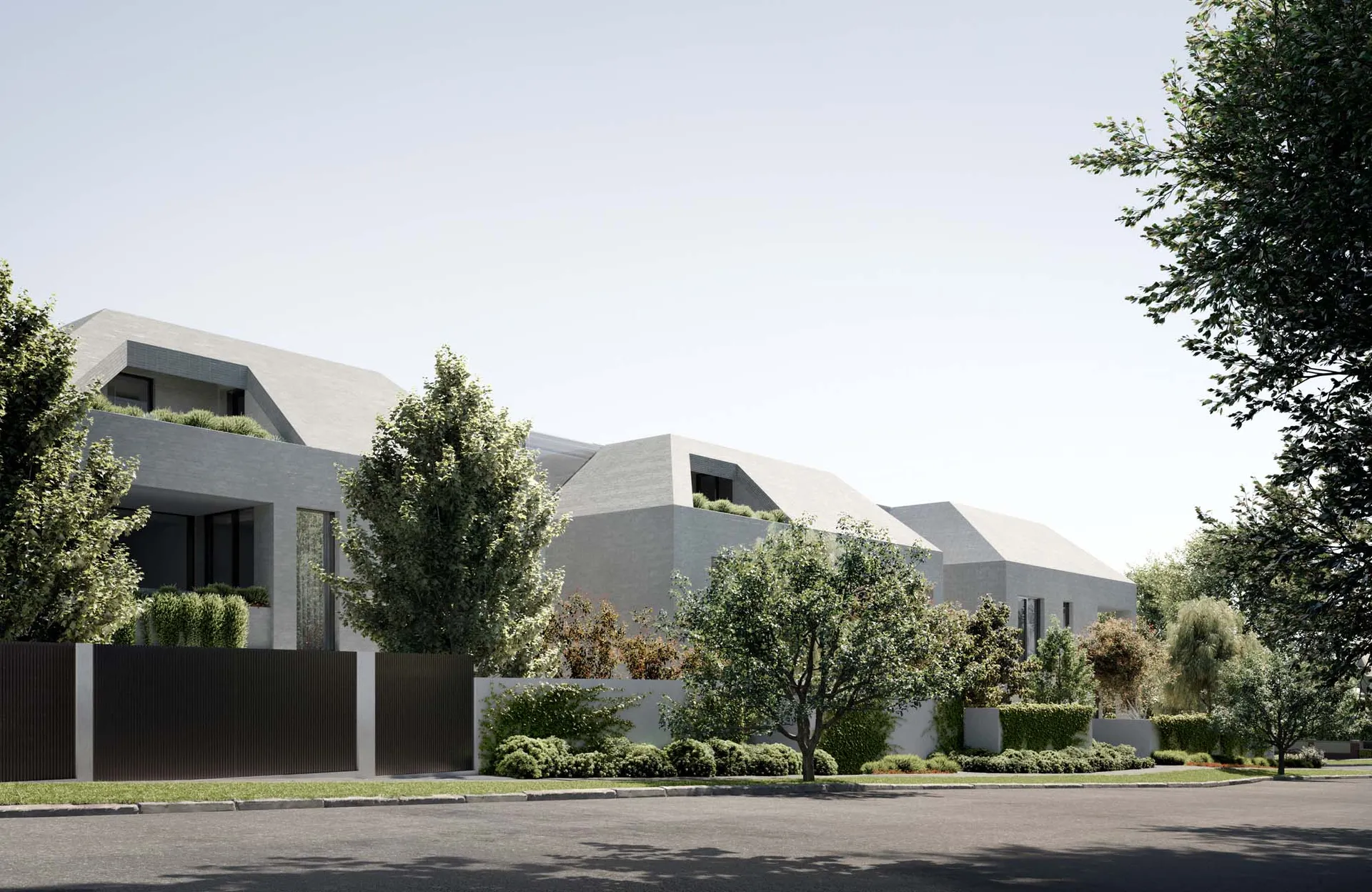 A modern residential exterior with concrete walls and a sloped roofline, surrounded by green foliage and a well-maintained la