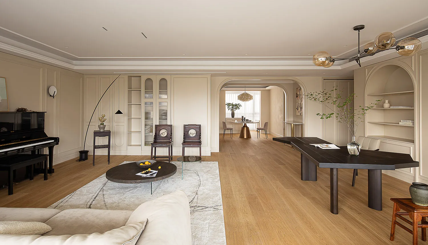 A modern living room with wooden furniture and fabric upholstery.