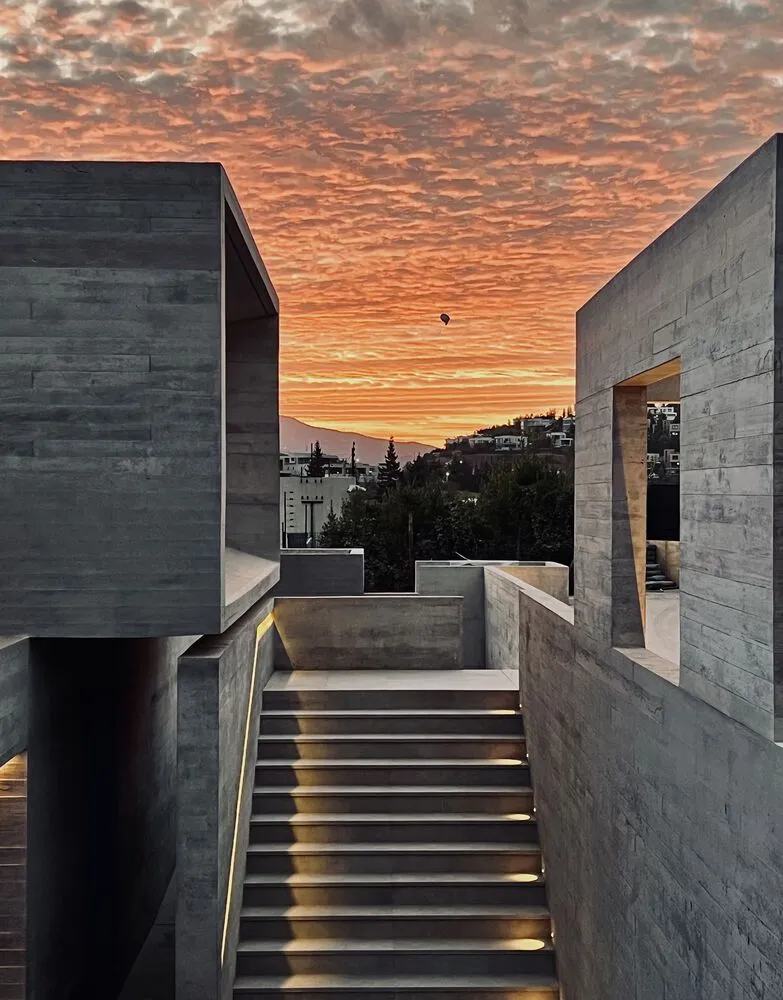 Modern, concrete staircase with illuminated steps.
