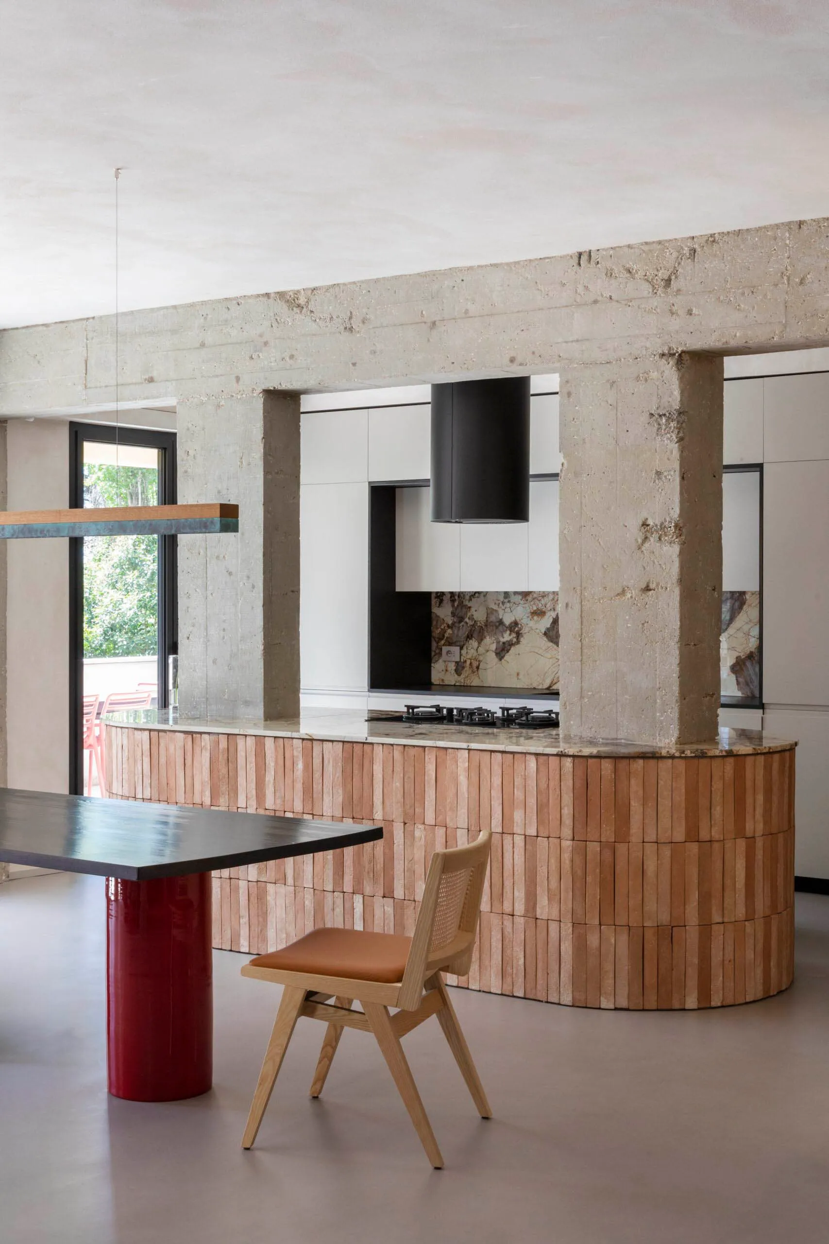 A modern minimalist kitchen featuring a wooden kitchen island and pendant lighting.