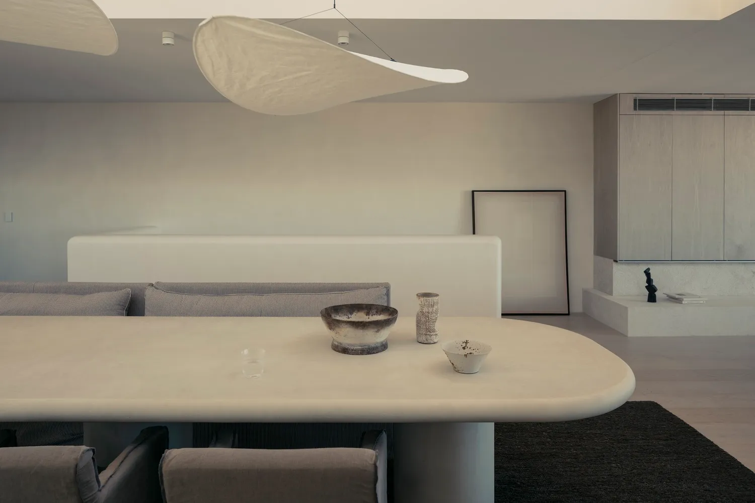 A modern living room with concrete furniture and minimalist design.