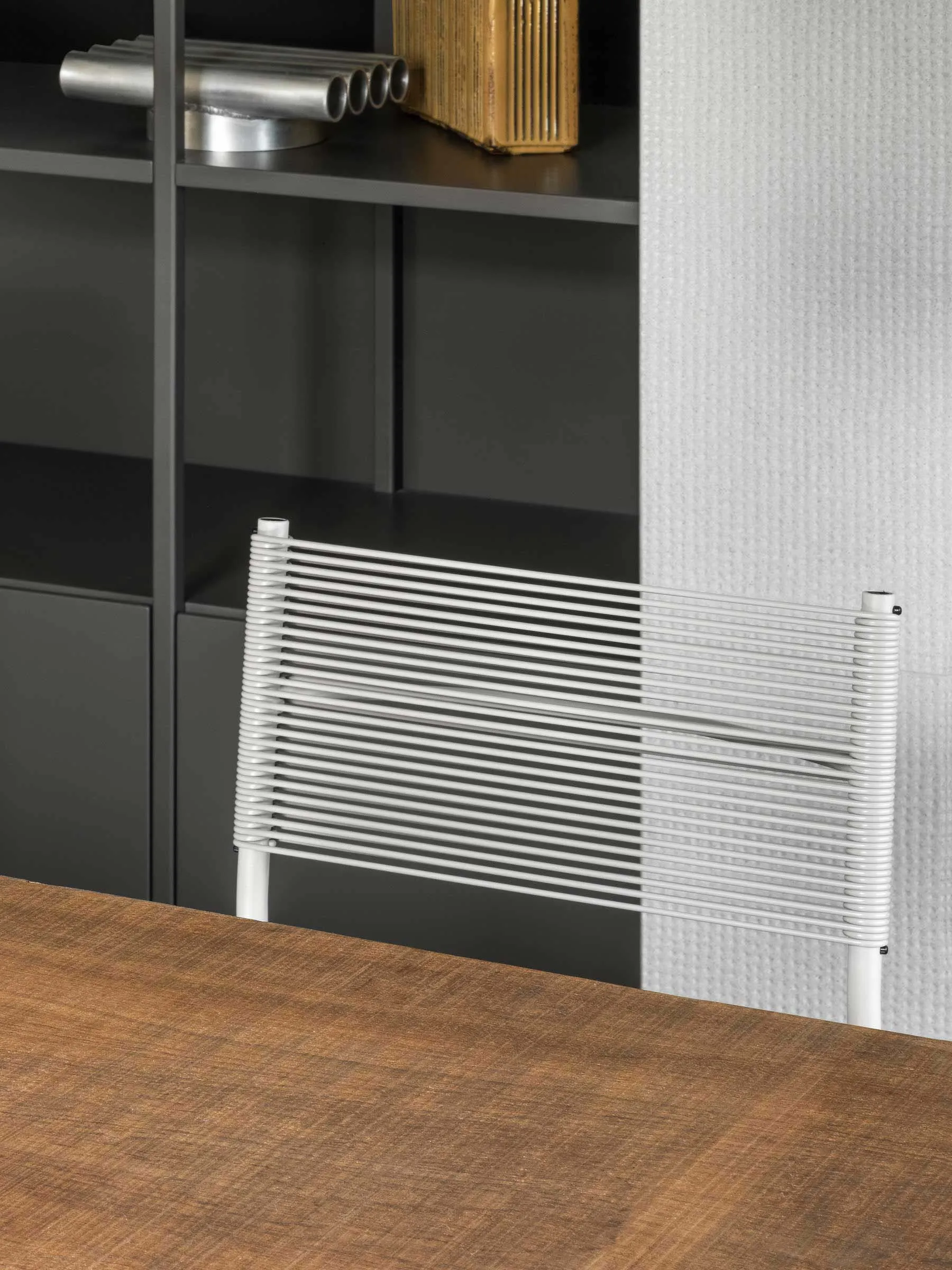 A modern, white desk with a metal frame designed for a home office.