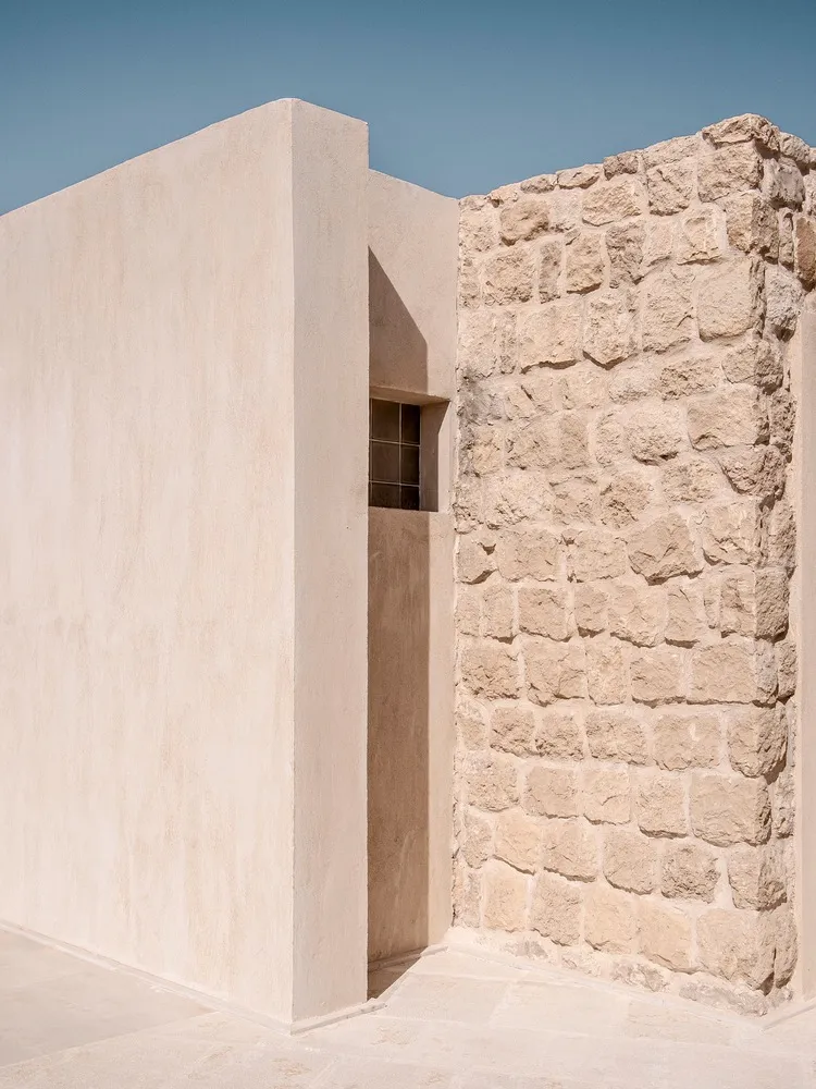 Modern exterior wall made of concrete and stone materials.