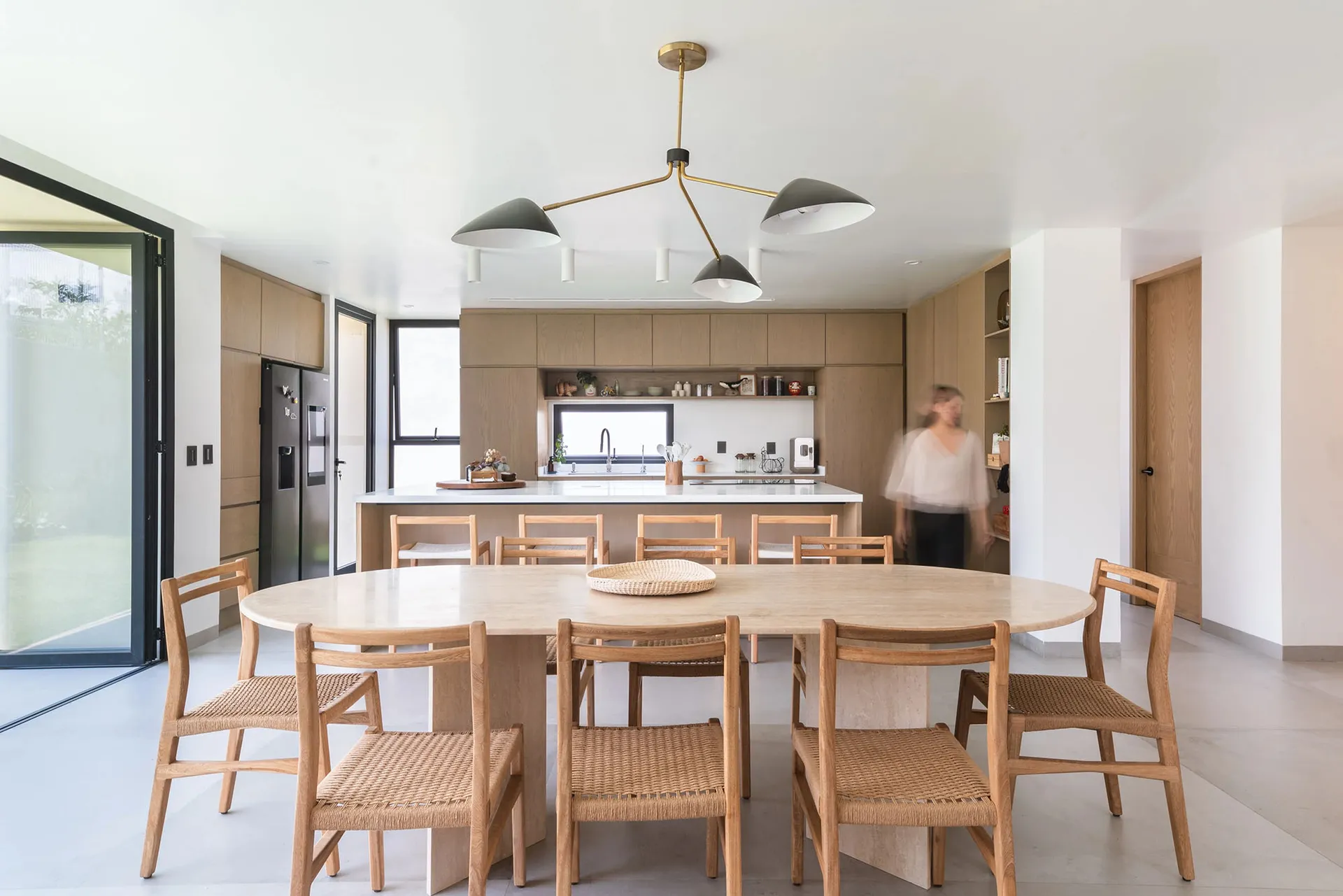 A modern minimalist dining room featuring a wood dining table and chairs