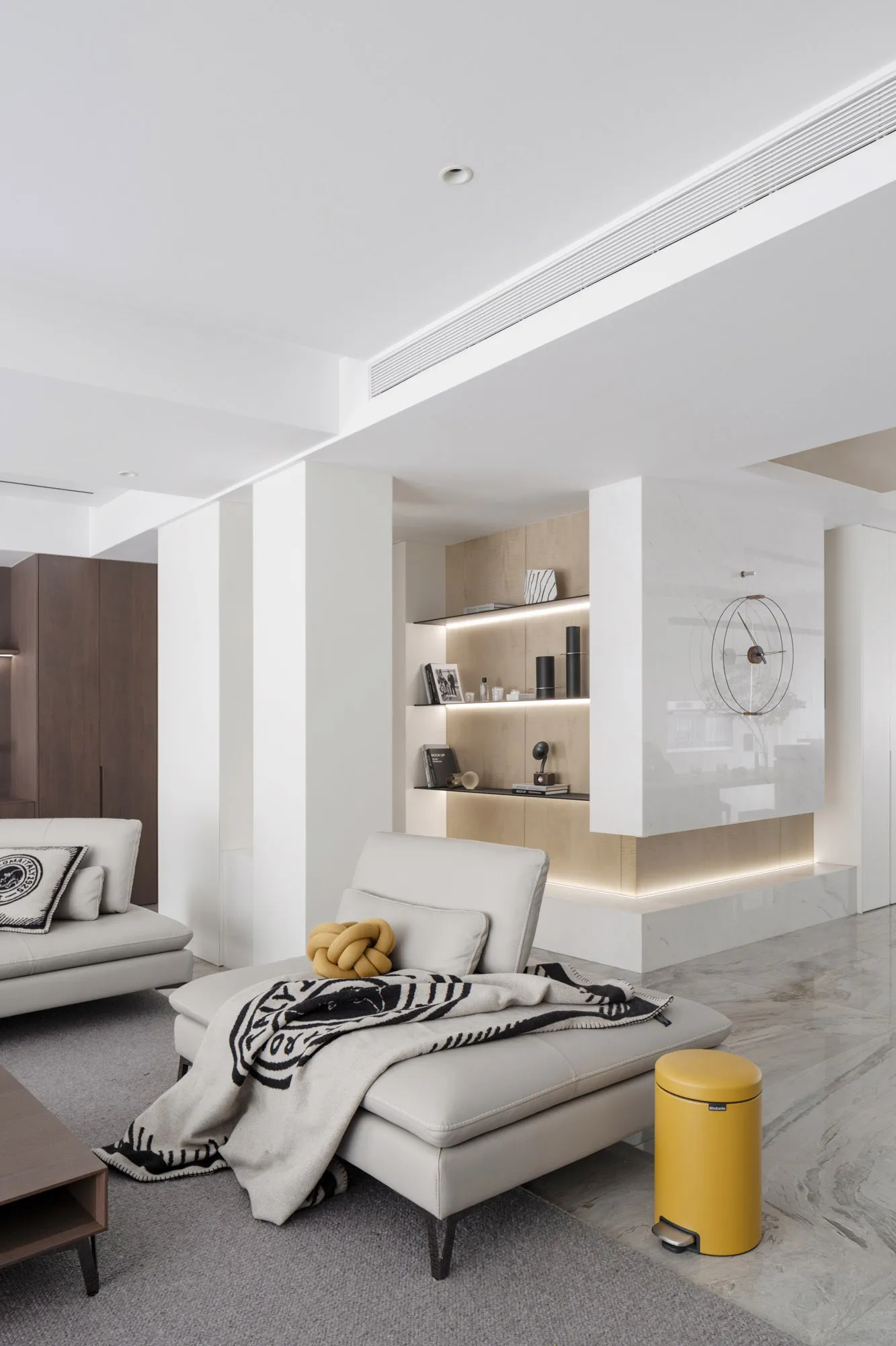 Modern living room featuring neutral-toned leather furniture, minimalist design, and sleek, contemporary decor.