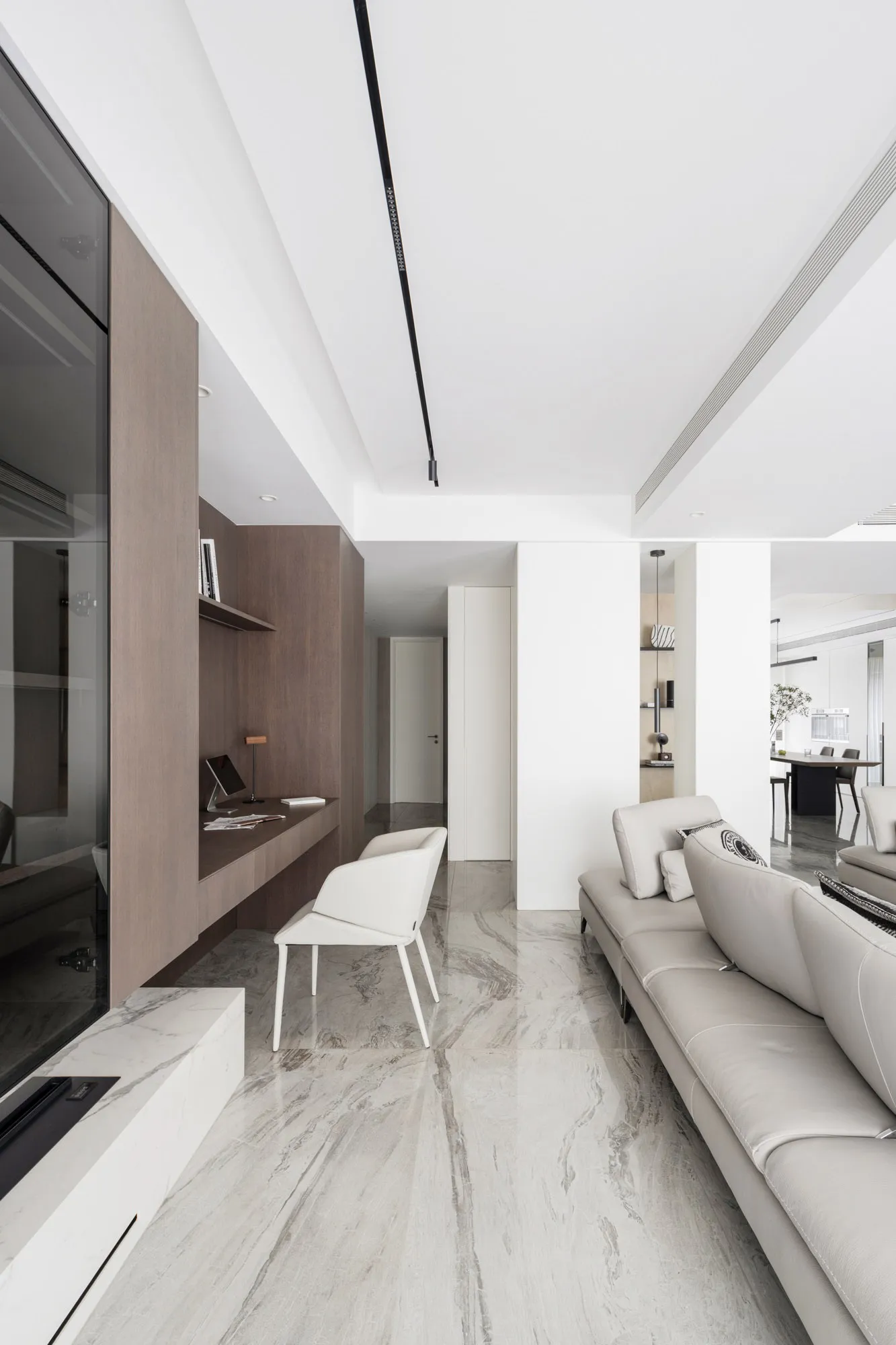 A modern living room with marble flooring and a white sofa.