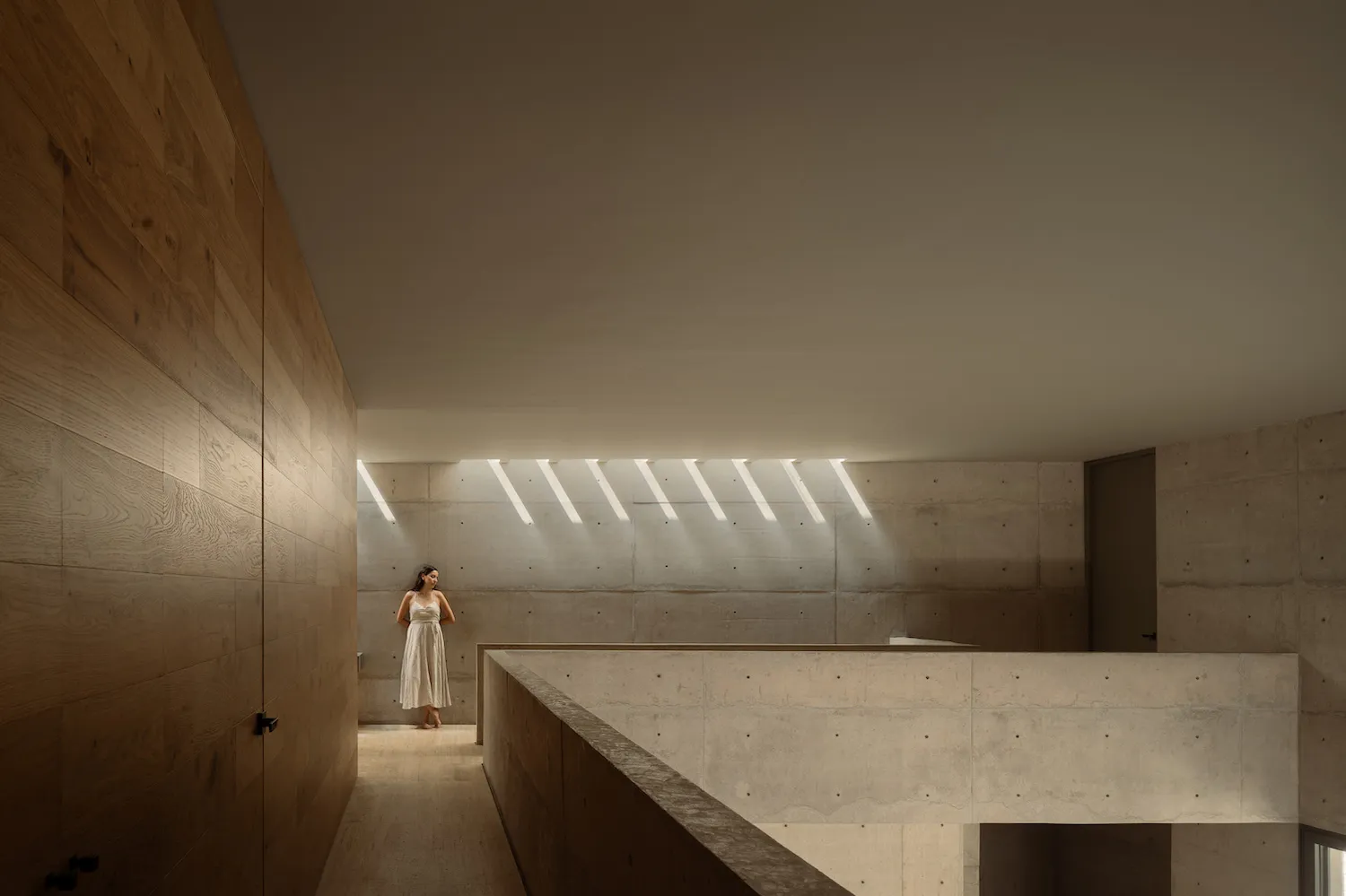 A modern residential space featuring concrete and wooden walls.
