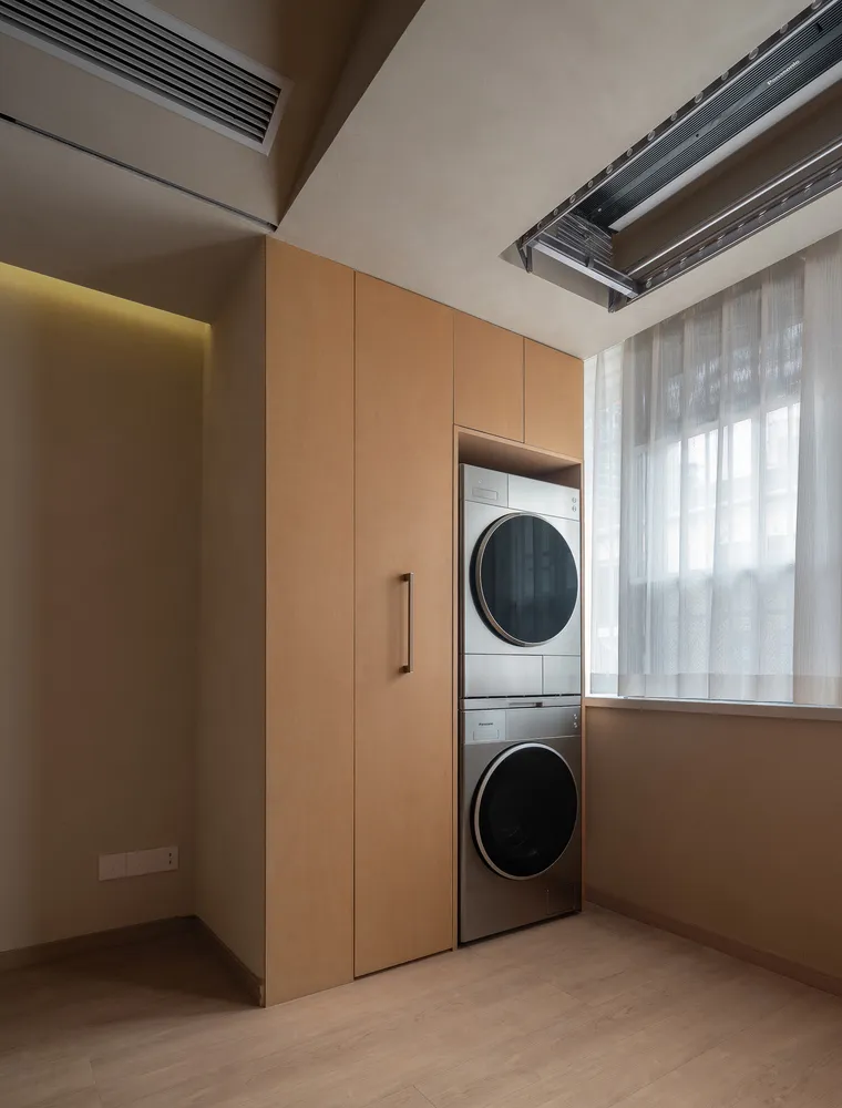 Modern laundry room featuring wooden cabinets, stainless steel washing and drying machines, and an open-air window.