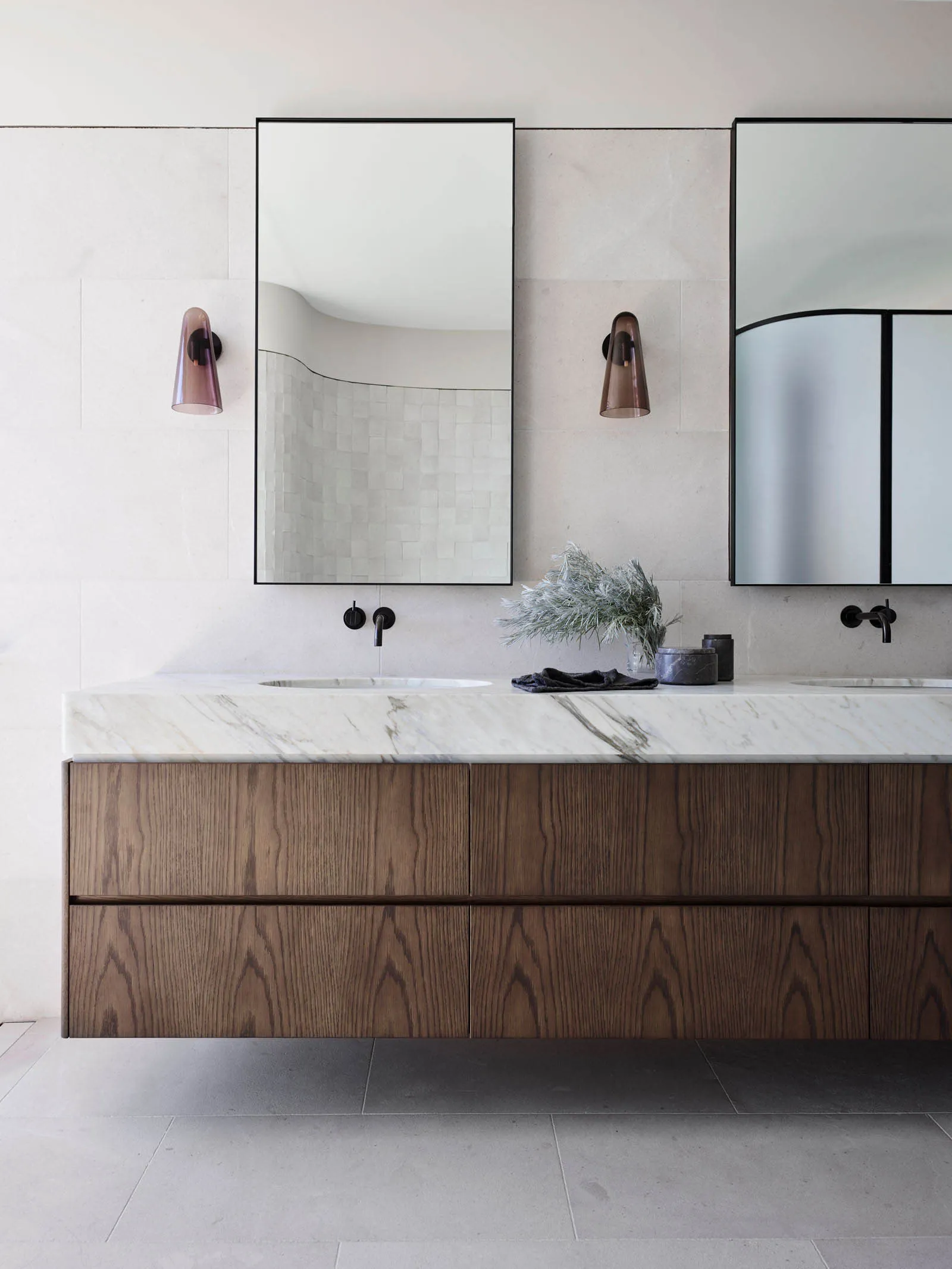 Modern bathroom with marble countertop and wooden drawers, featuring sleek design and minimalist aesthetic