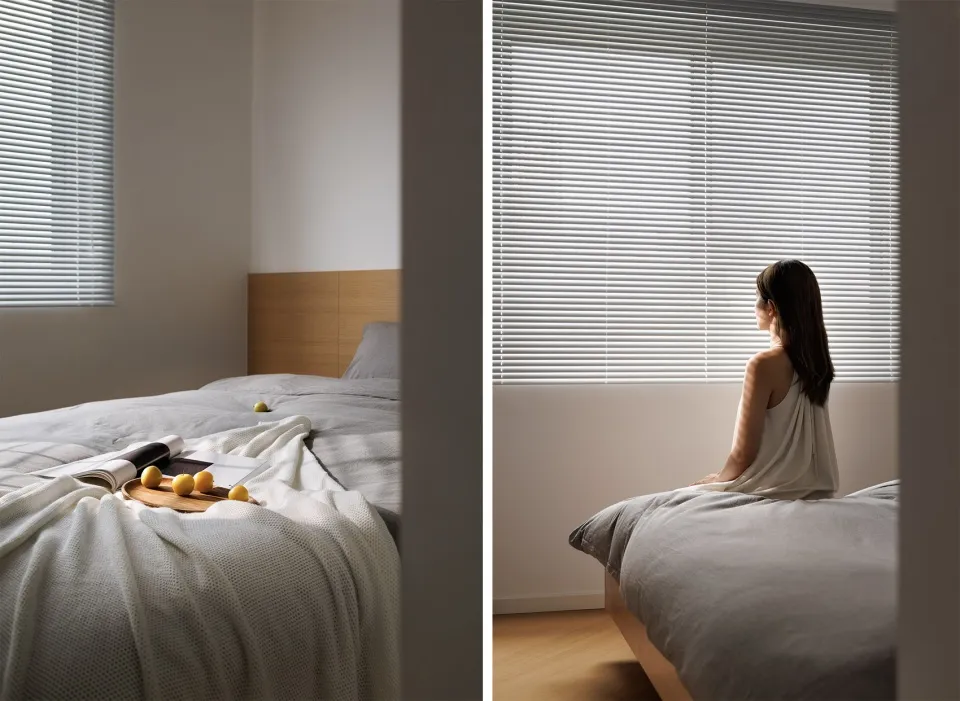 A minimalist bedroom featuring window blinds.
