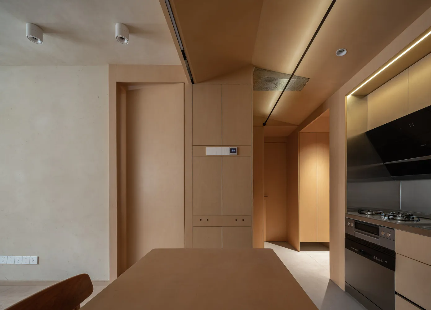 A modern kitchen featuring wooden furniture and a clean, minimalist design.