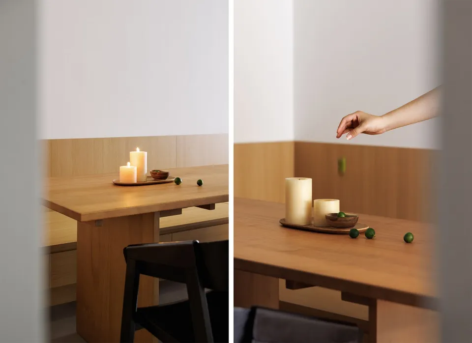 Modern dining room featuring wooden furniture, candles, and green decorations
