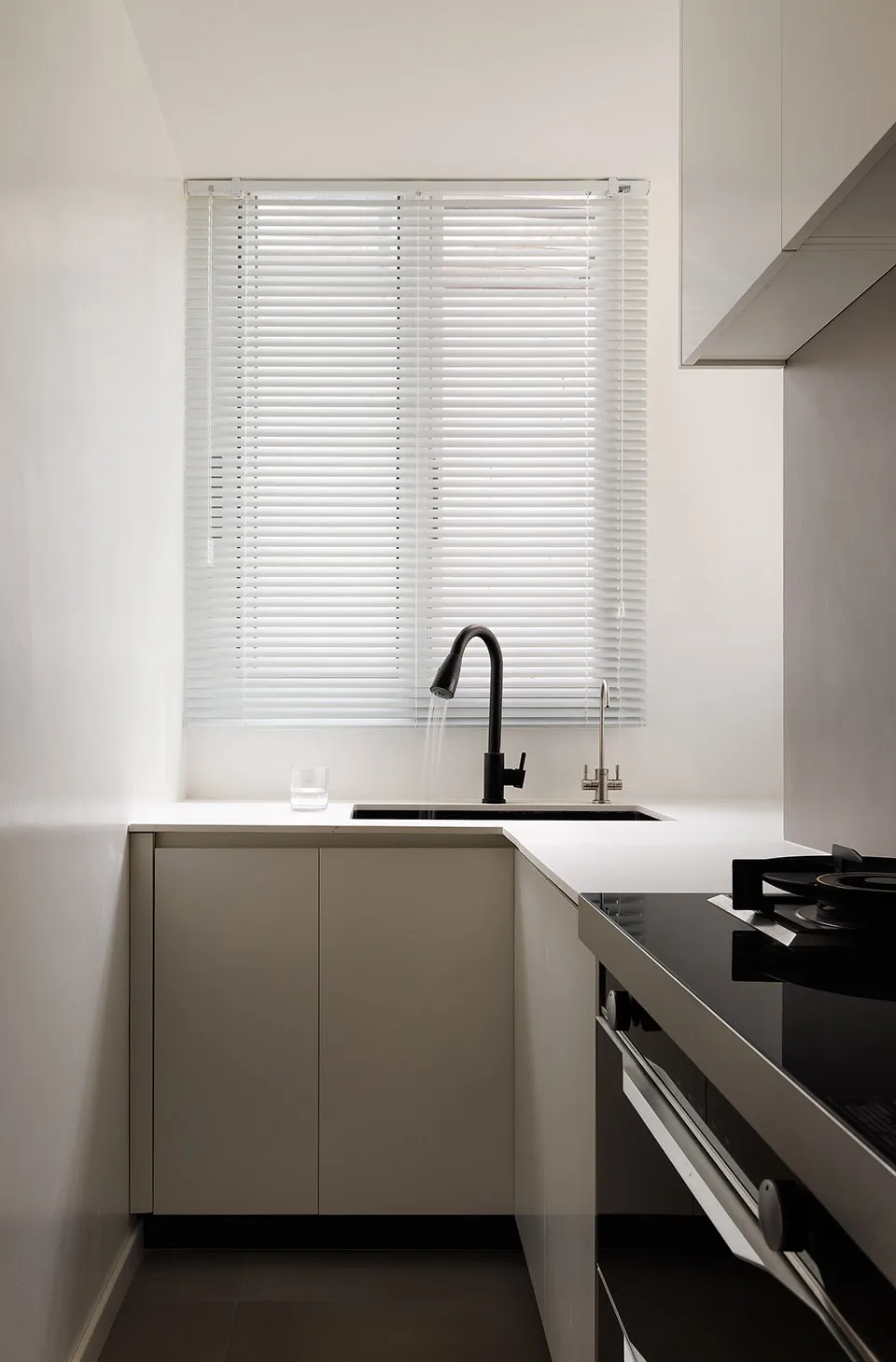 Modern kitchen featuring a white quartz countertop and minimalist design.