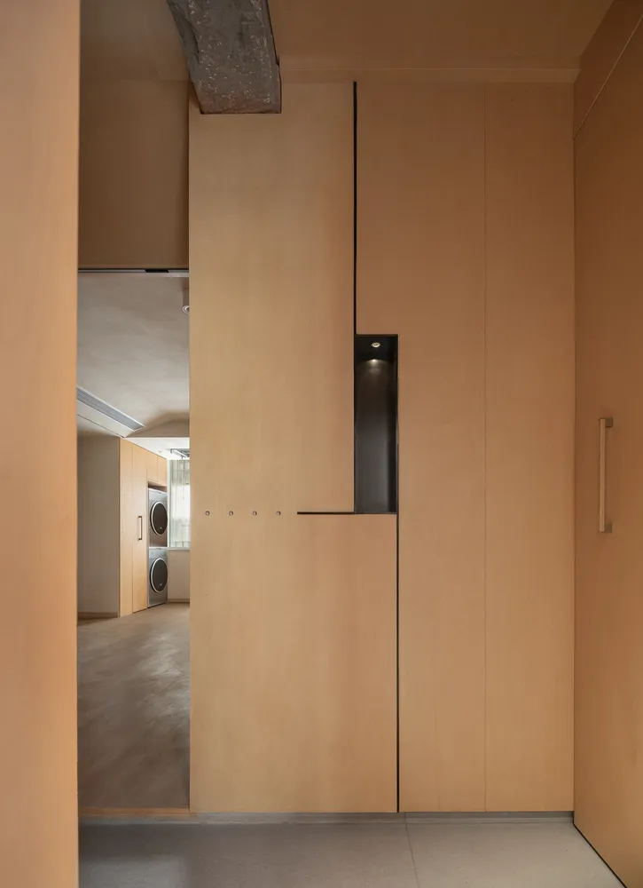 A modern wardrobe closet with wooden panels, featuring sleek design and minimalist style.