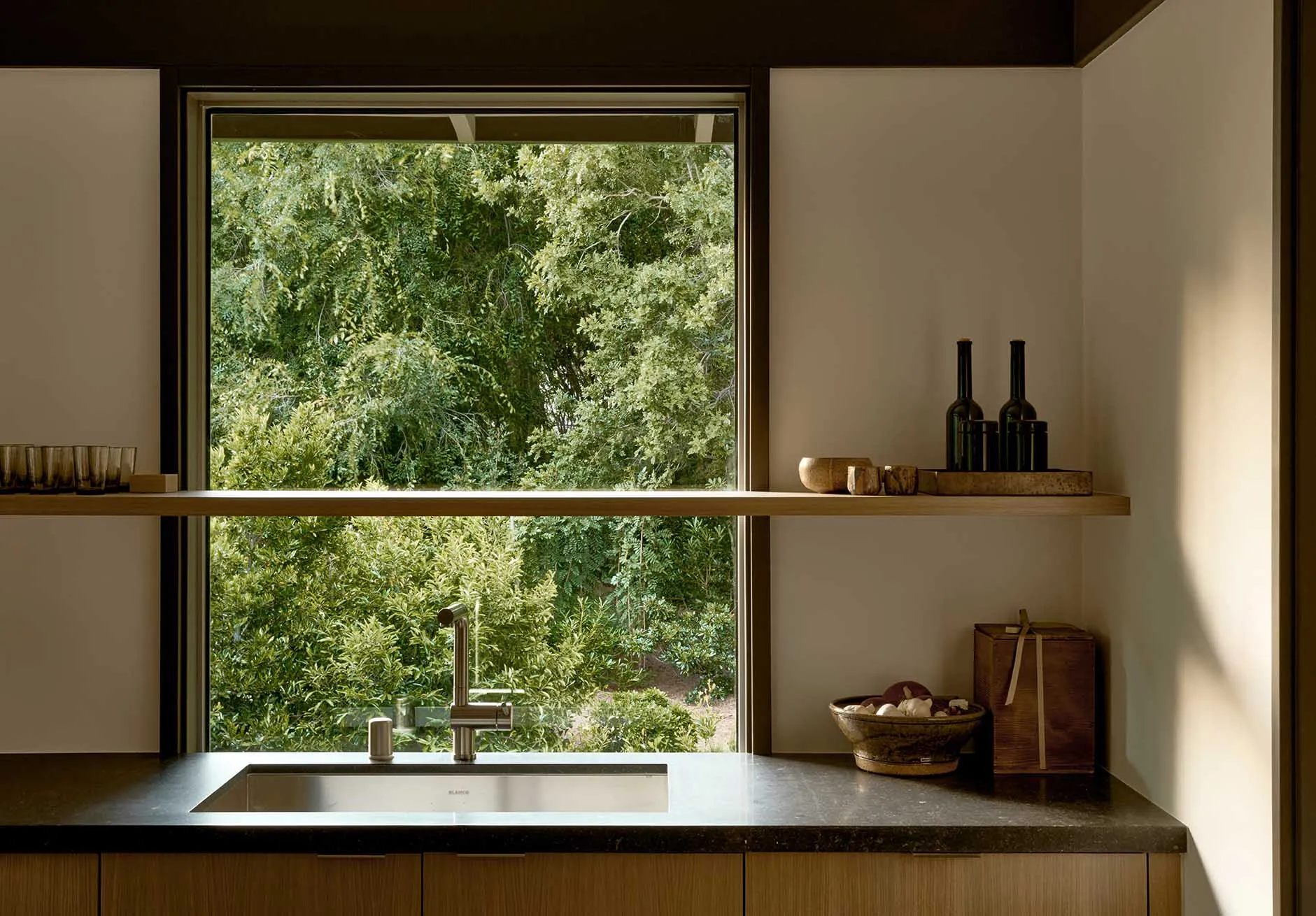 Modern minimalist kitchen with glass countertop.