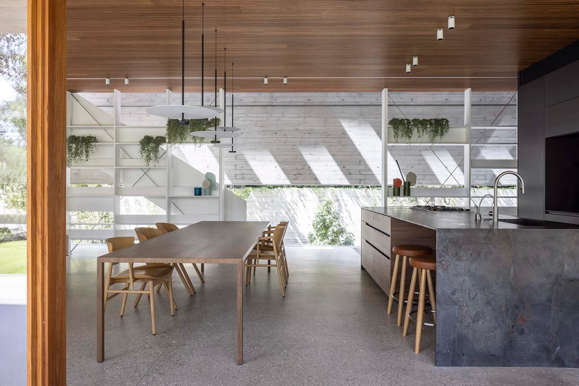 A modern kitchen with a concrete countertop and minimalist design.