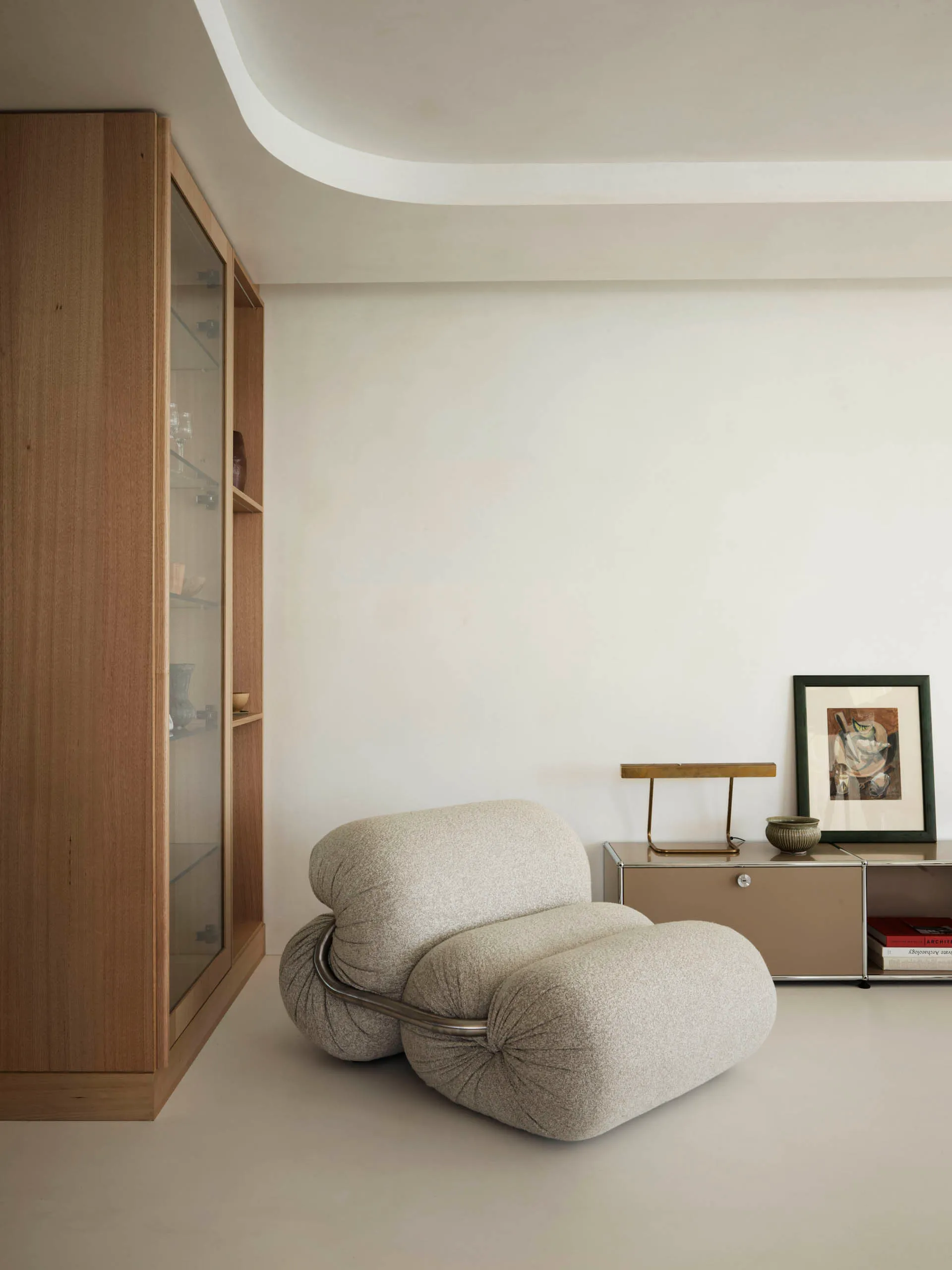 Minimalist living room featuring a comfortable upholstered sofa and decorative elements on a low cabinet.