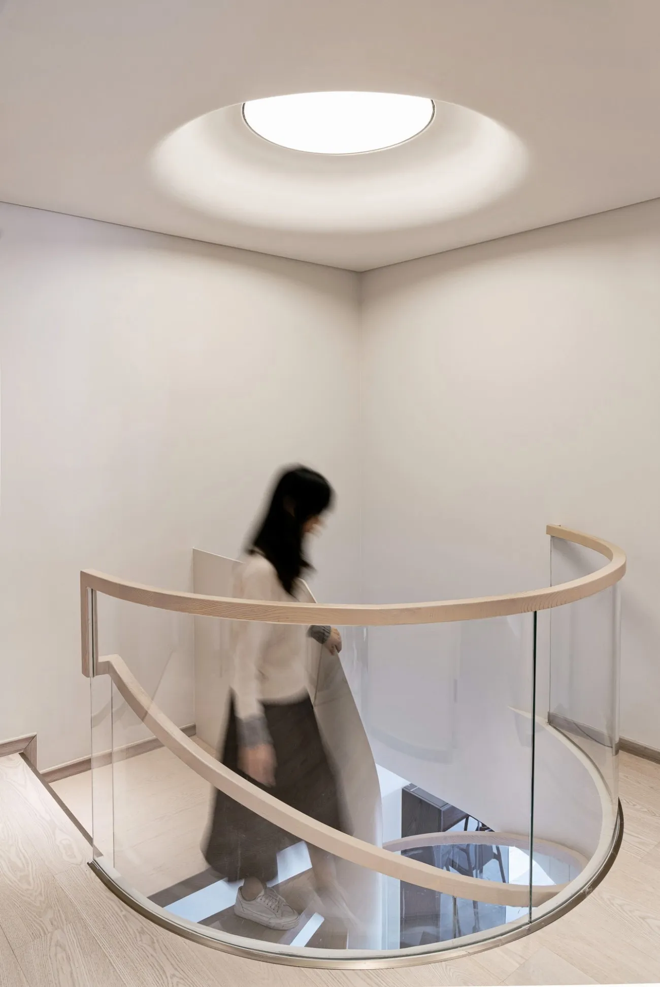 A modern interior space featuring glass and wood materials.