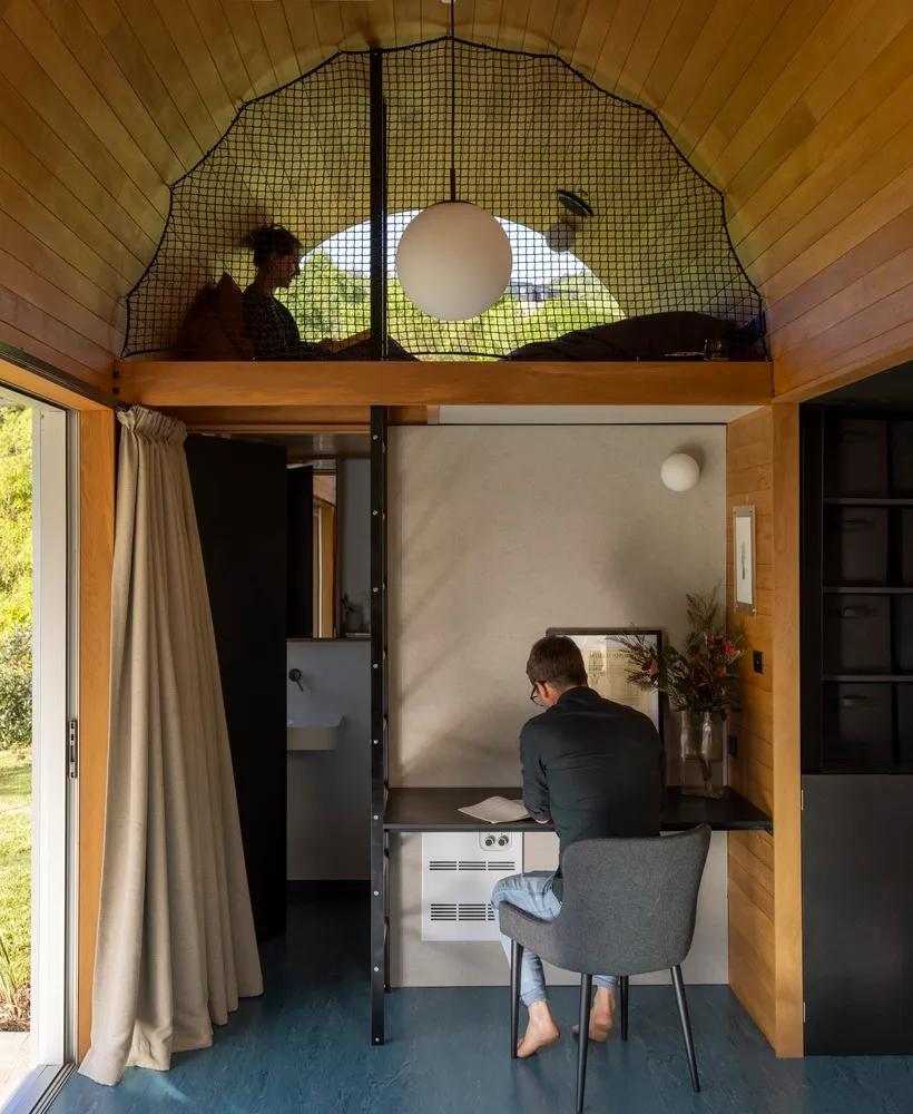 Minimalist home office with wooden elements and a desk.