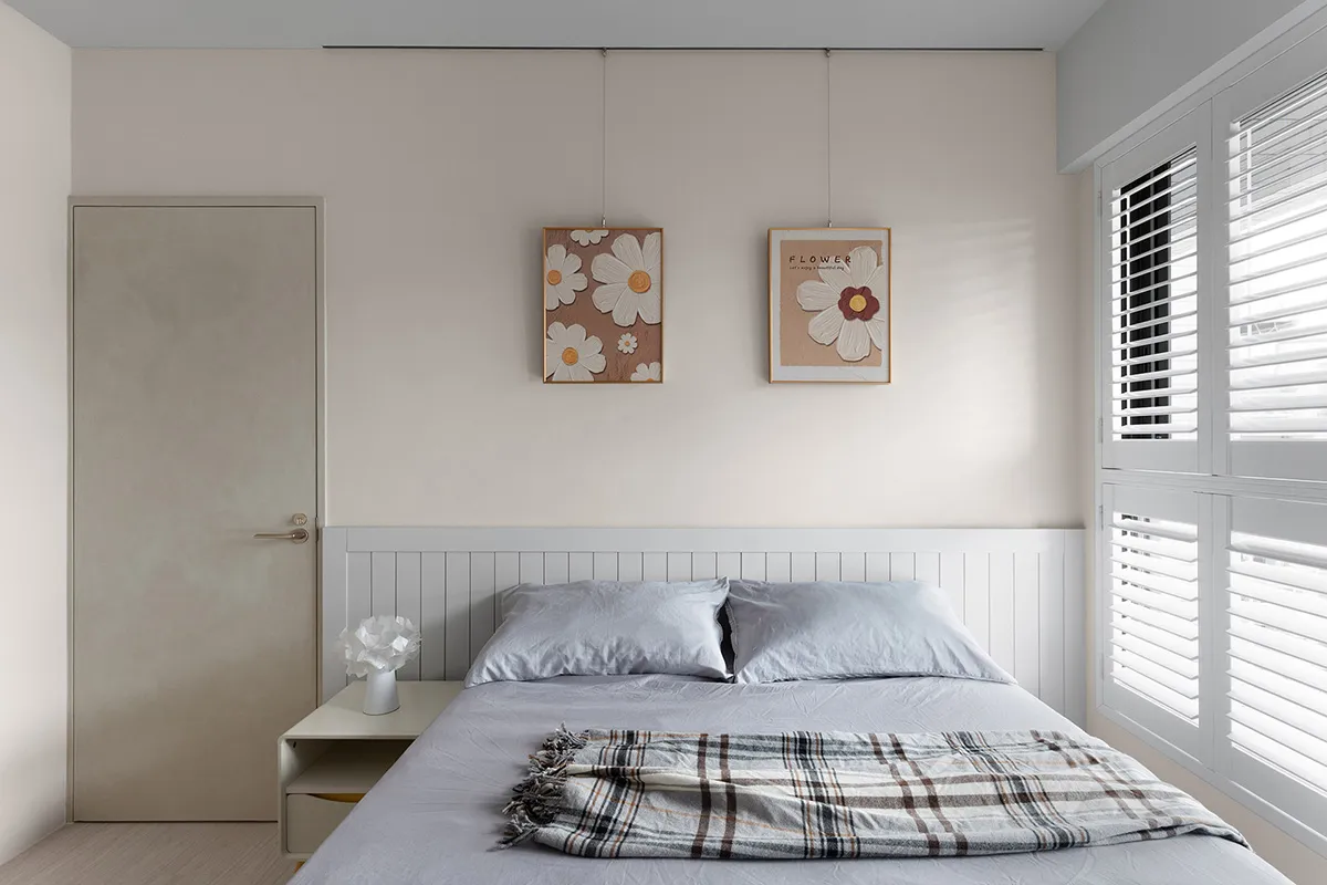 A minimalist bedroom featuring mixed materials and patterns.