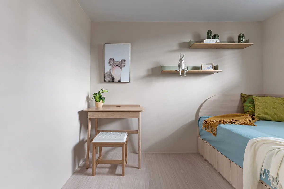 A minimalist bedroom featuring wood furniture.