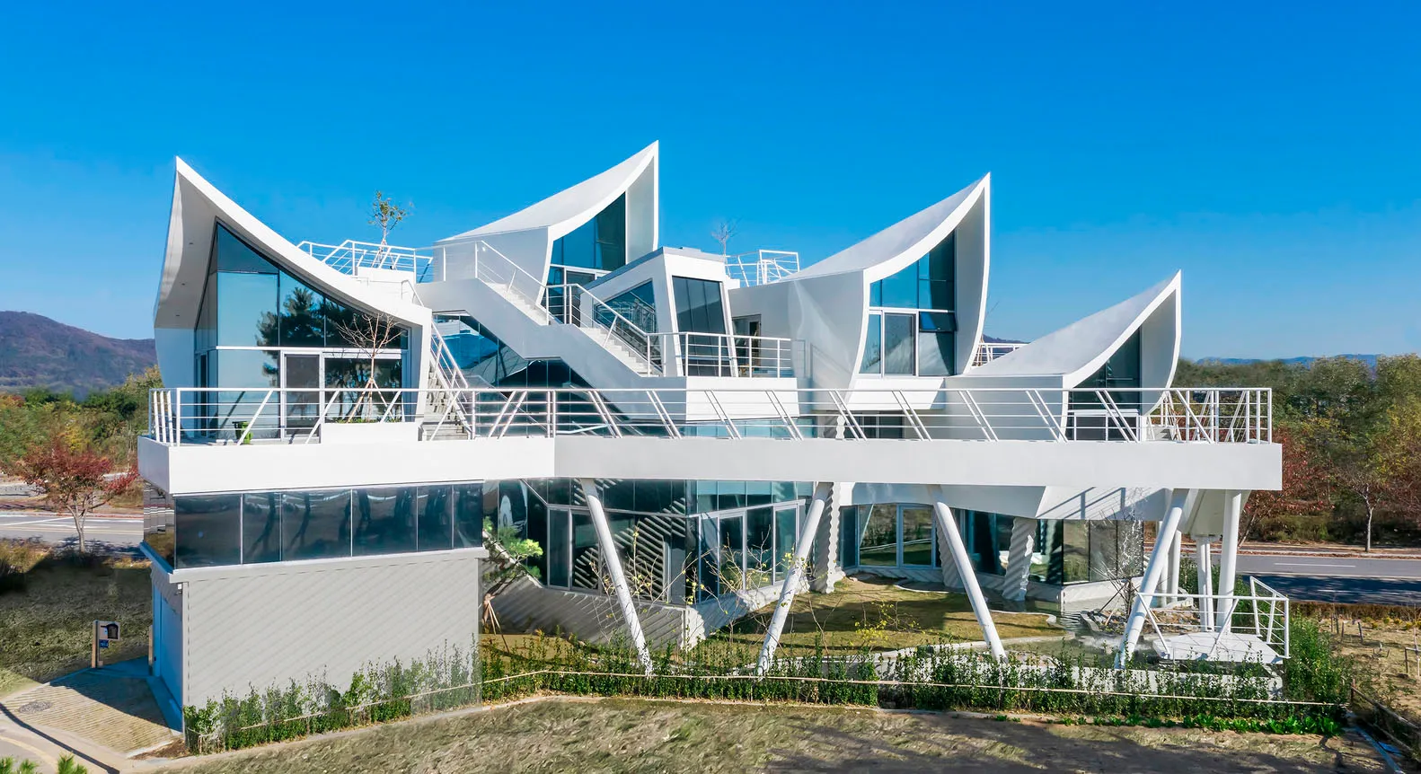 A modern building with a glass exterior and a white facade.