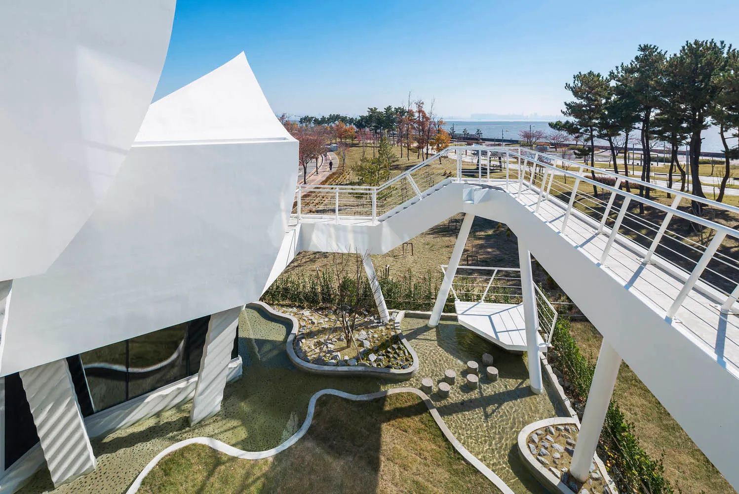 A modern park featuring concrete pathways and seating areas.