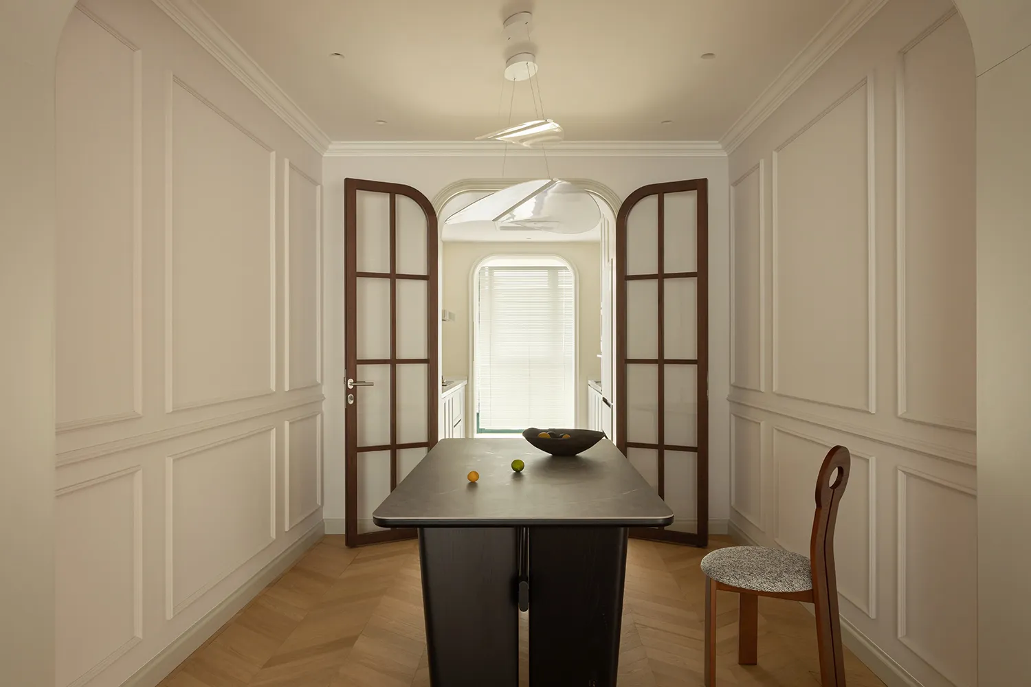 A modern residential entryway featuring wooden furniture and a glass panel door.