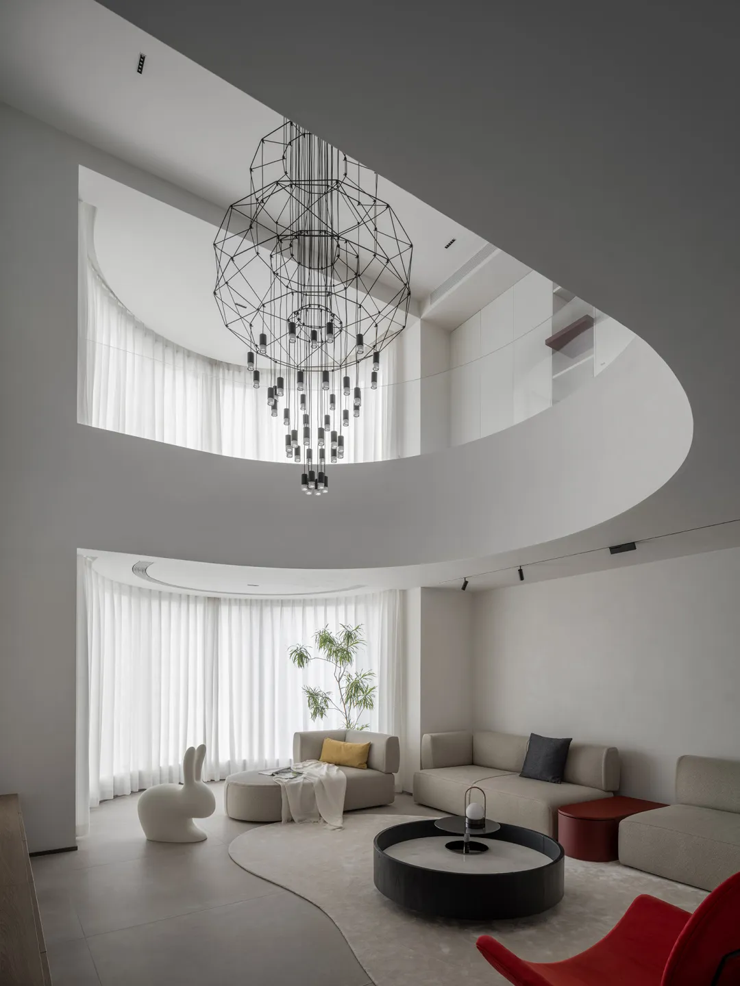 A modern living room featuring polished concrete laminate flooring and minimalist furniture.