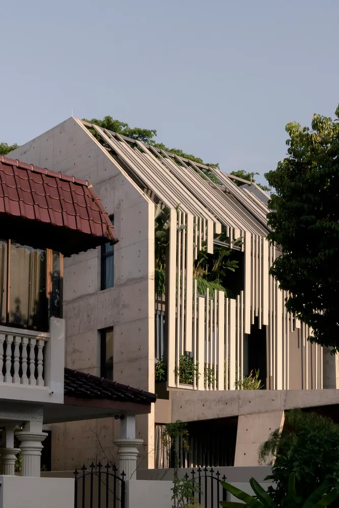 Modern house with a concrete exterior and slatted glass windows.